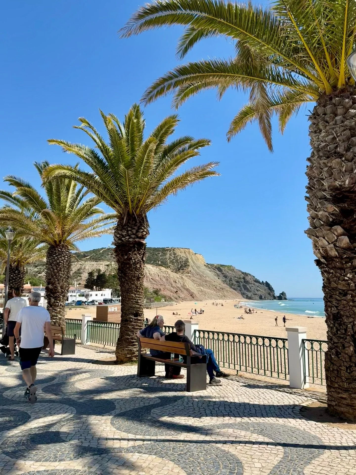 Wandering here feels like the world has paused just for you.

One of my favourite things in Luz is strolling the black-and-white Cal&ccedil;ada Portuguesa promenade. Hand-laid limestone mosaics trace the curve of the beach and crescent bay, creating 