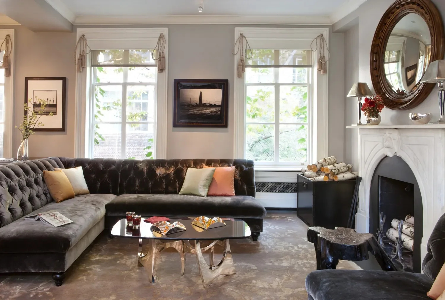 A rather standard size living room occupies the entire 3rd floor. And while the tufted sofa backs reflect some Victorian influence, the lamps on the mantel and custom table base definitely do not.