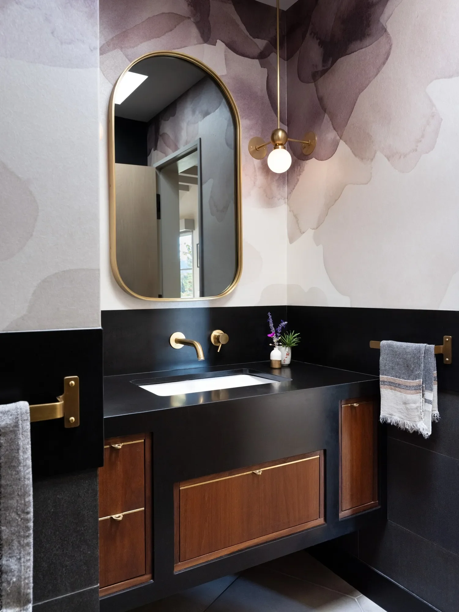 That brass mirror frame, brass pendant and brass cabinet hardware were all custom-fabricated for the hallway bathroom.