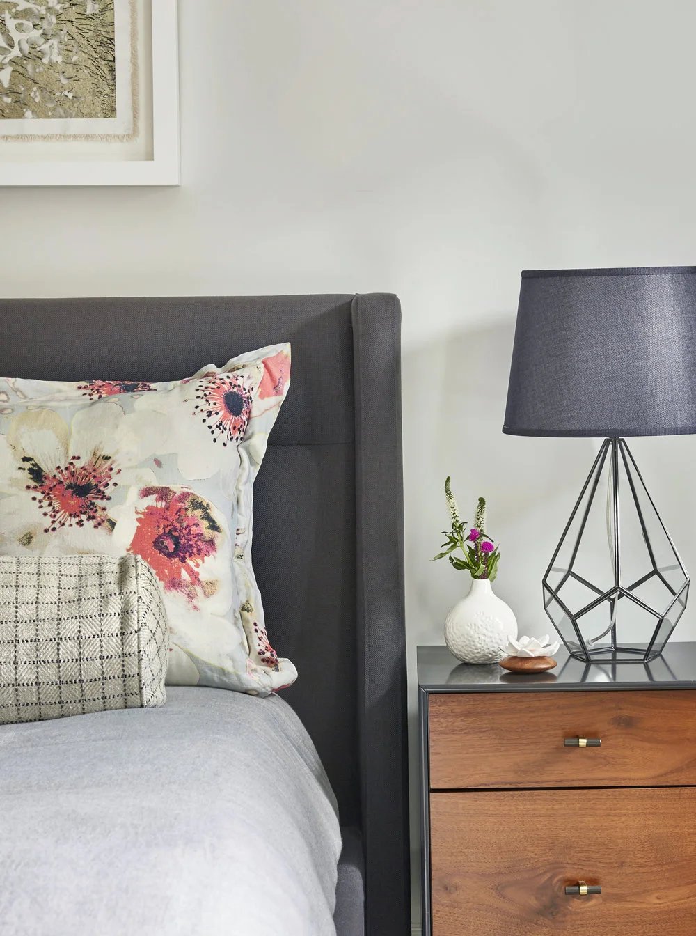A traditional modern bedroom in grey hues with floral pops, part of our ‘ Fresh, Fantastic and Fun on 1st Street ’ project.
