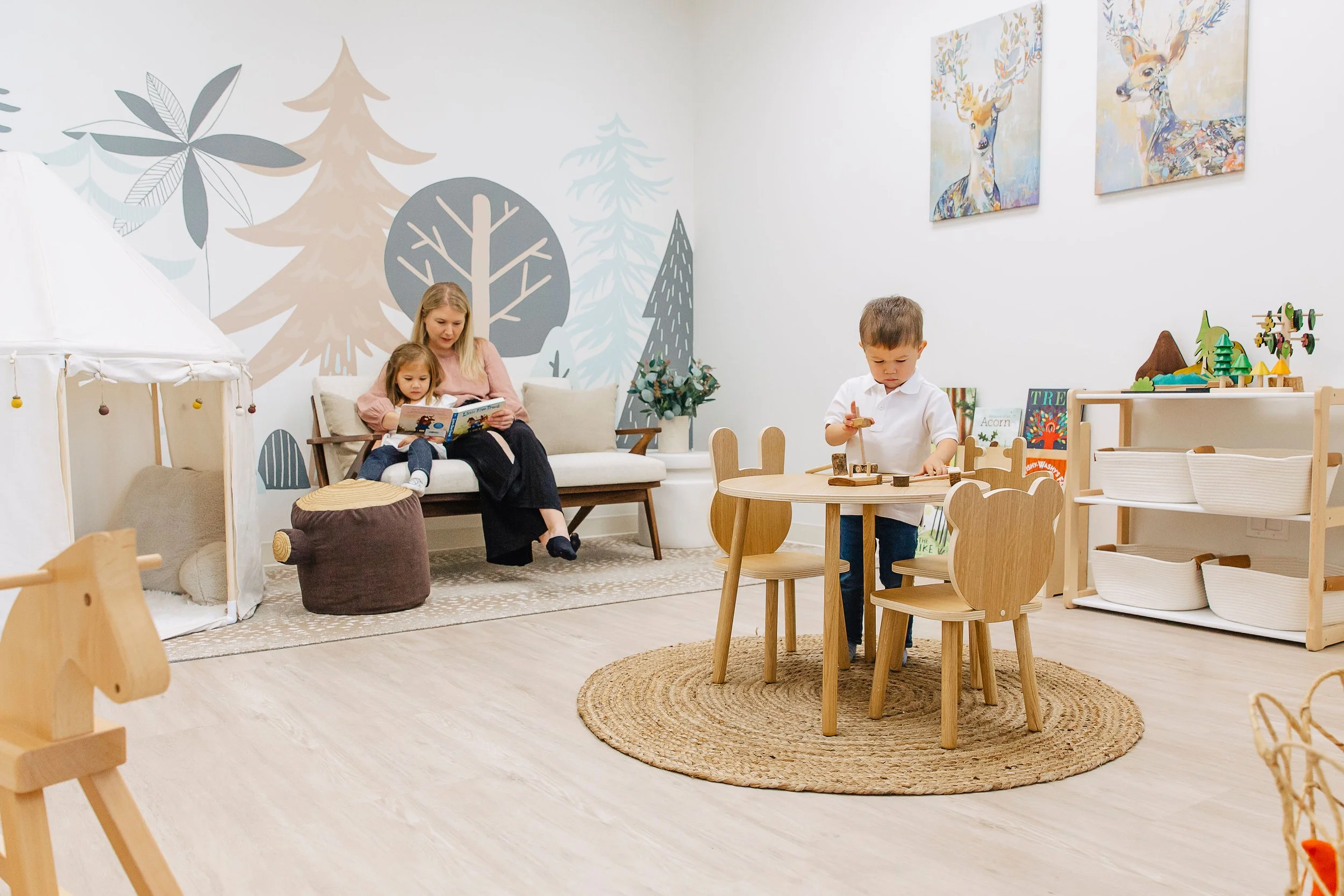 Mural of graphic style trees painted by Oregon artist Amanda Donahue of The Scribblist for indoor playspace for kids Leka Playland.