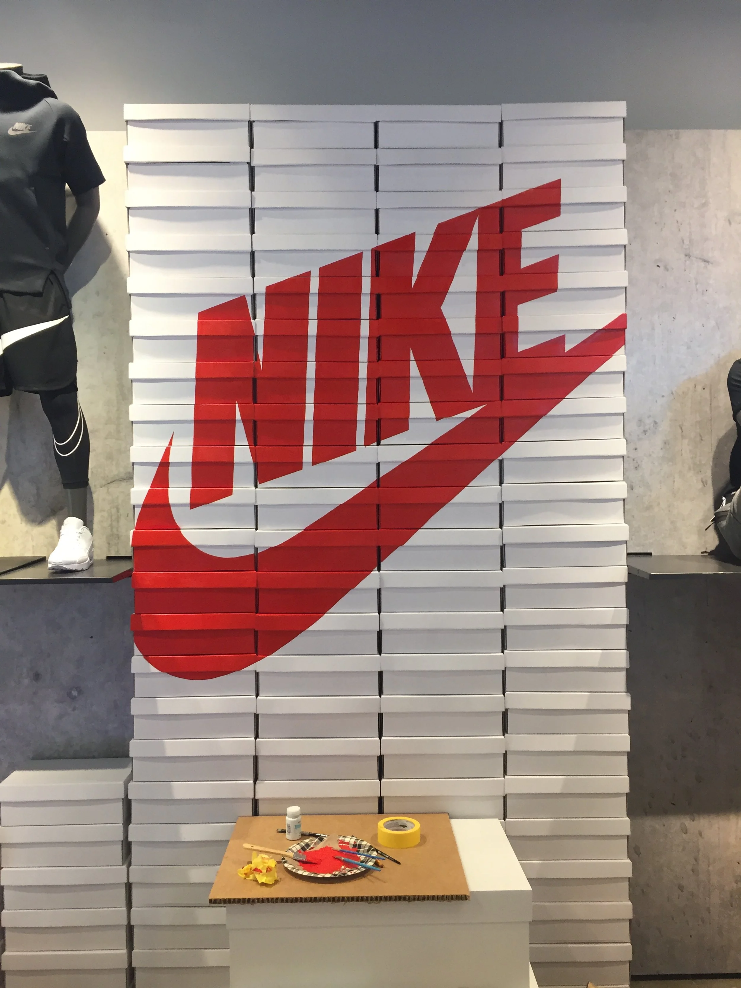 Mural of the Nike logo and swoosh in red on white shoeboxes at Nike World Headquarters by Oregon artist Amanda Donahue of The Scribblist