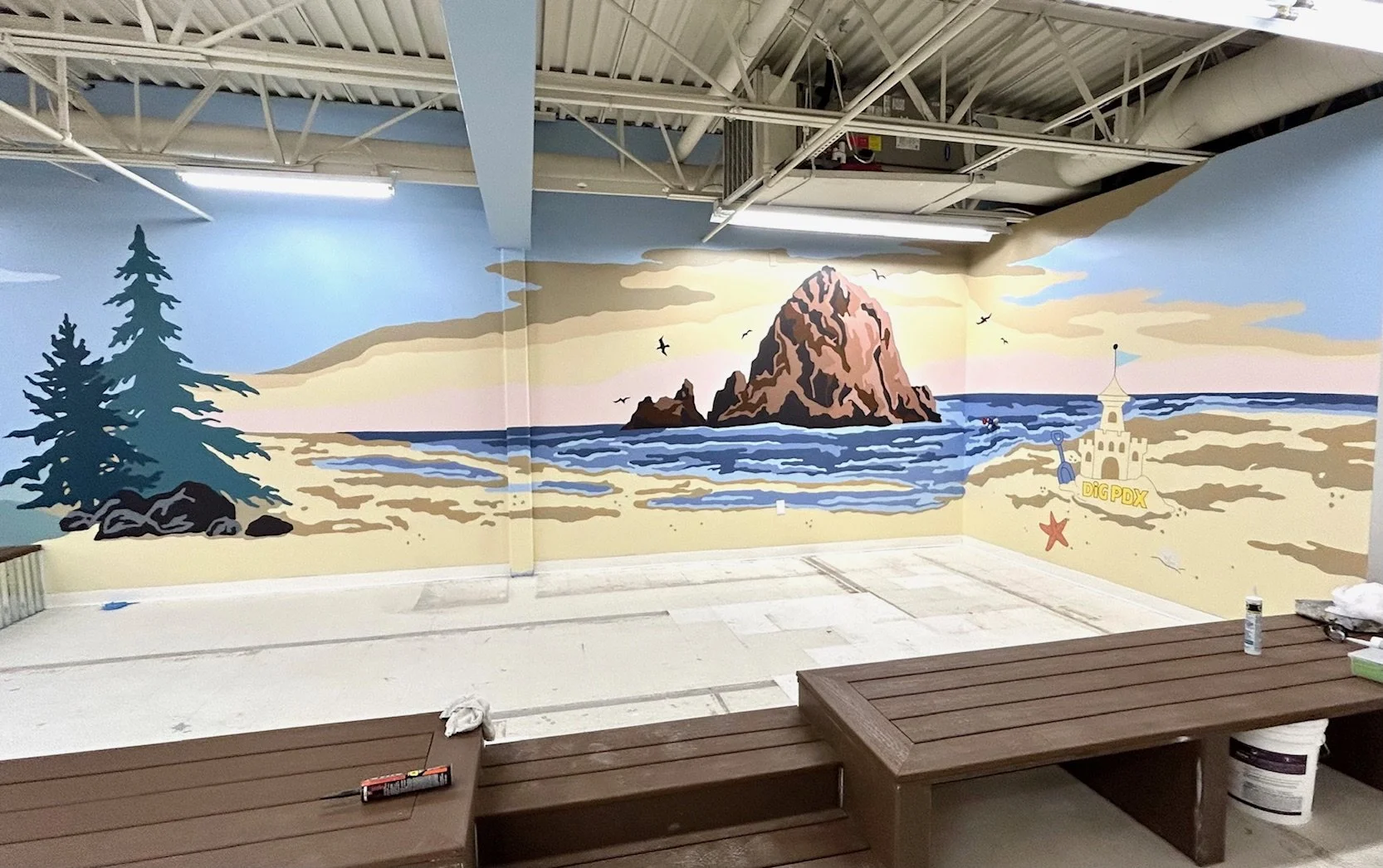 Mural of the Oregon Coast featuring a sandcastle and Haystack Rock by artist Amanda Donahue of The Scribblist at DigPDX