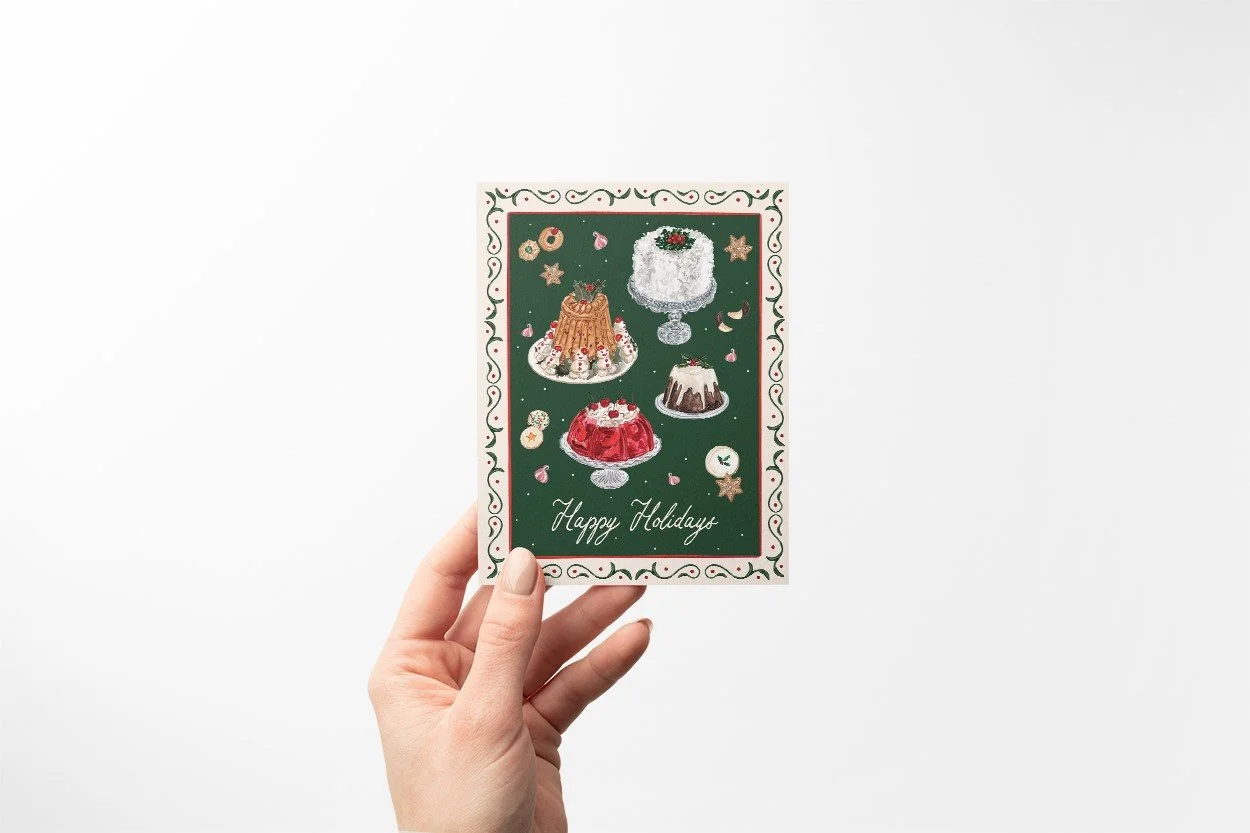 Vintage Christmas Desserts Happy Holidays Card by The Scribblist held by a hand