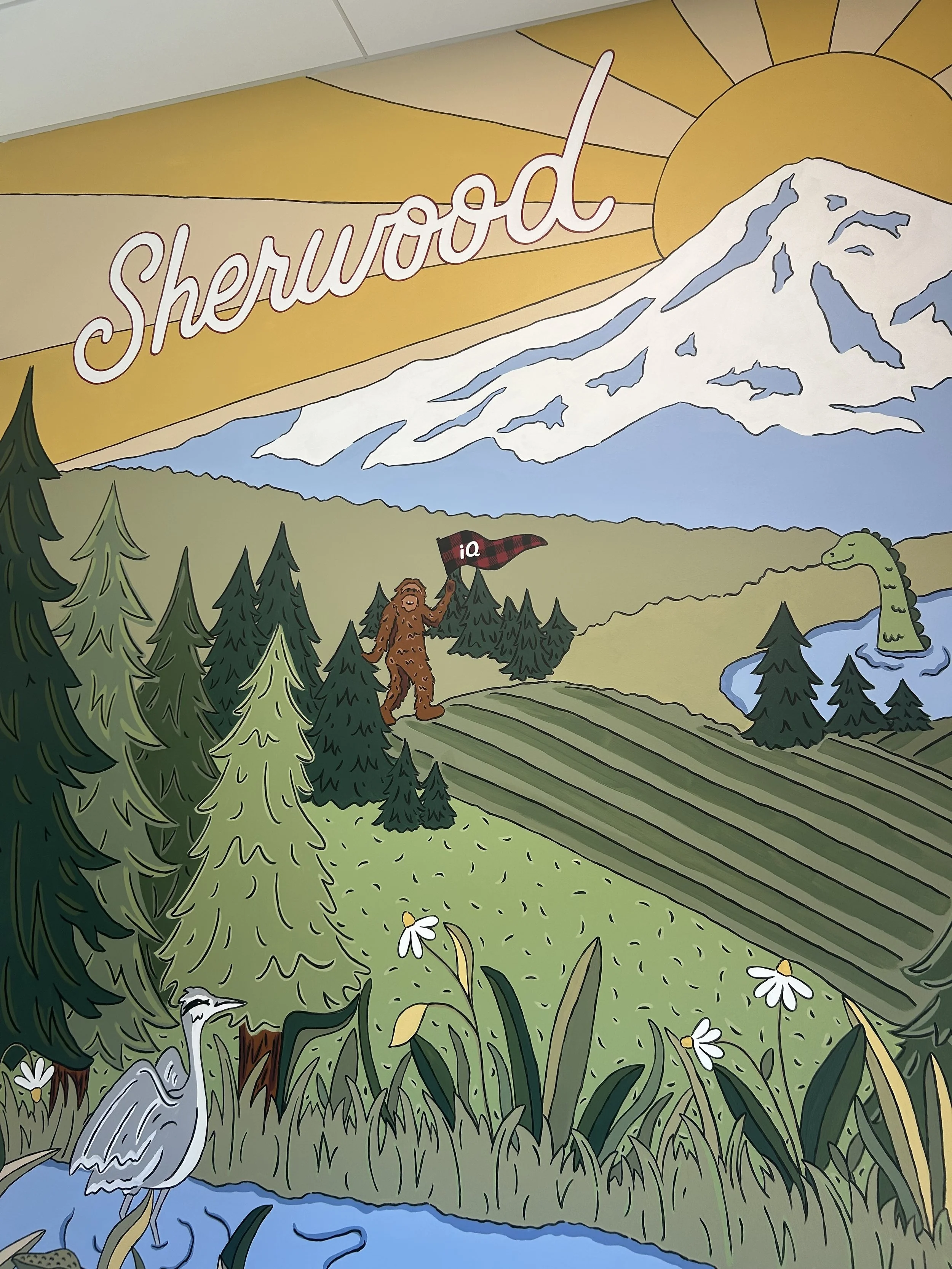 Detail of a sasquatch holding a flag in a Sherwood Oregon landscape for a mural at iQ Credit Union by artist Amanda Donahue of The Scribblist