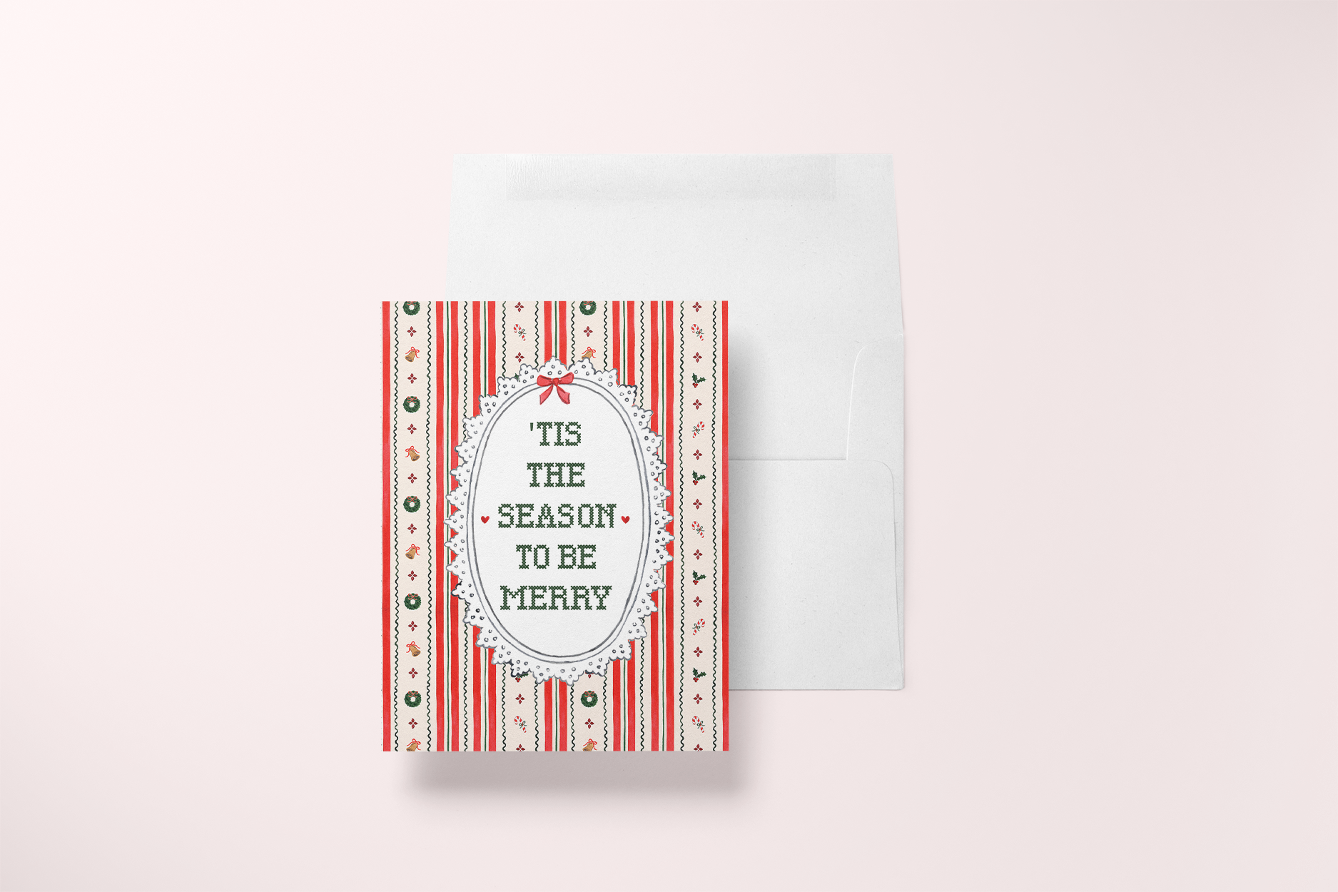 Tis the Season to Be Merry watercolor card featuring candy cane stripes, wreaths, bells, and cross stitch lettering with envelope