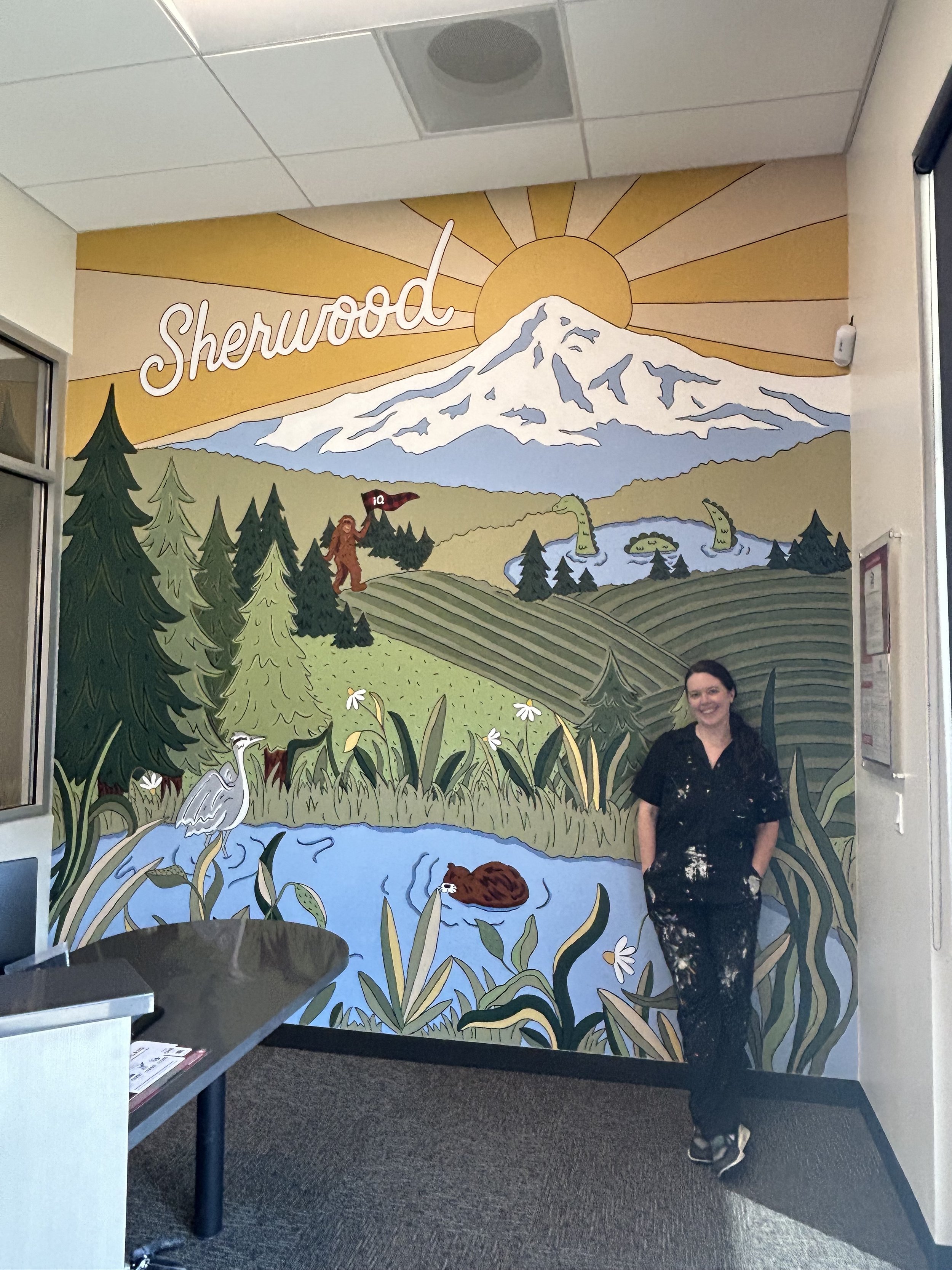 Colorful mural of Oregon landscape in Sherwood with a crane, beaver, and Sasquatch by artist Amanda Donahue of The Scribblist
