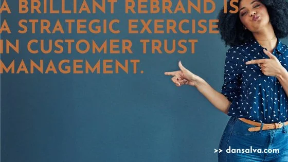 Woman pointing to the headline that reads: "A brilliant rebrand is a strategic exercise in customer trust management."