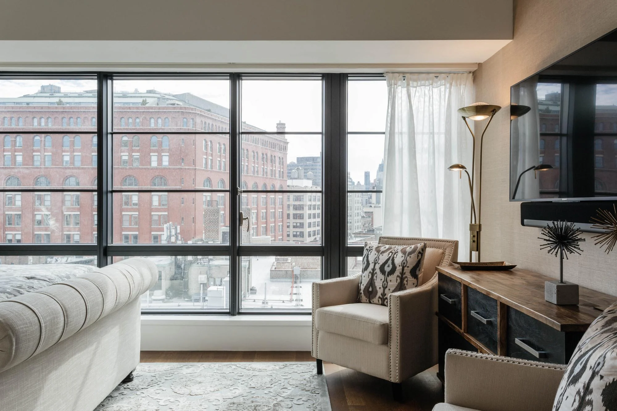 Bedroom with wooden console and mounted TV