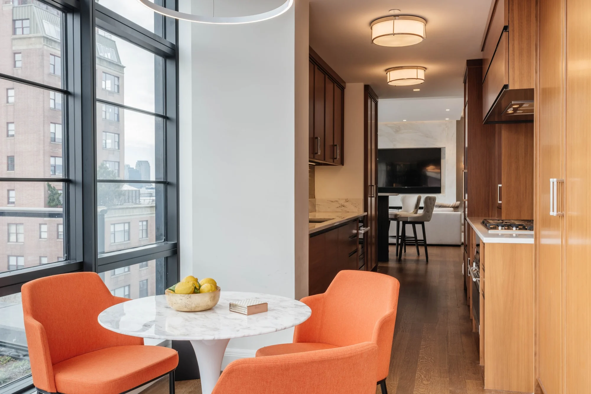 Bright breakfast nook with orange chairs