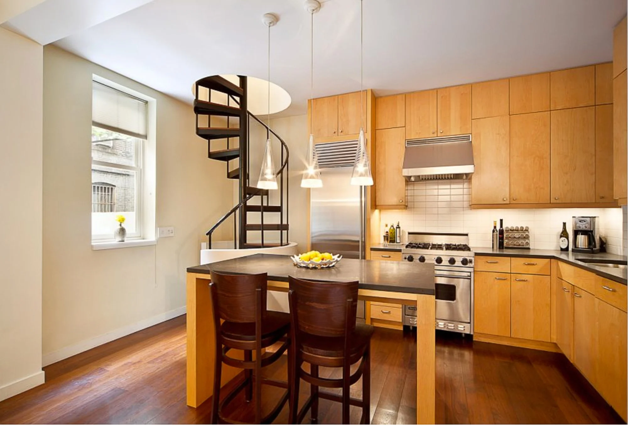 Modern kitchen with spiral staircase leading through the ceiling