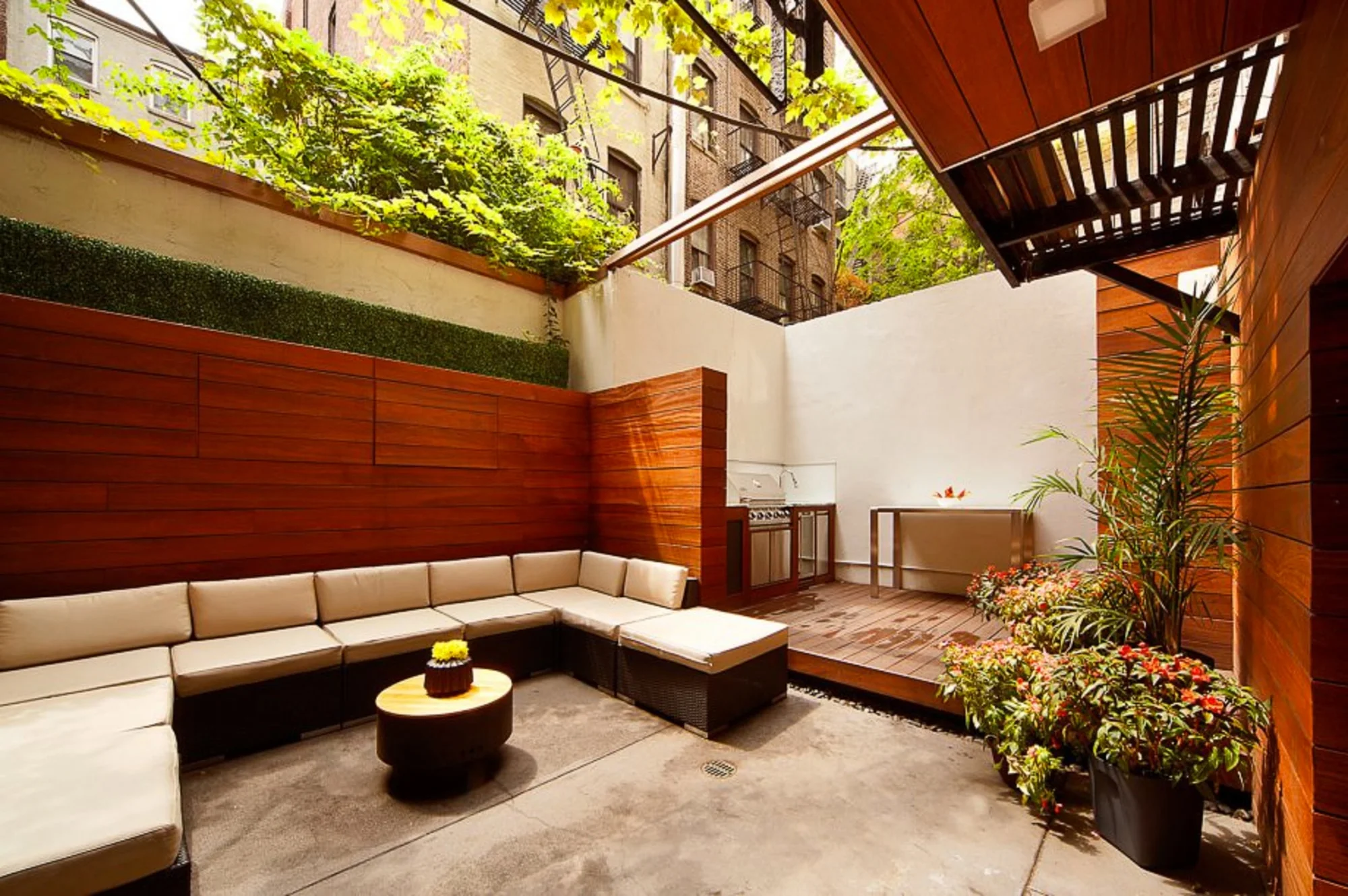 Outdoor seating area with wood panels and potted plants
