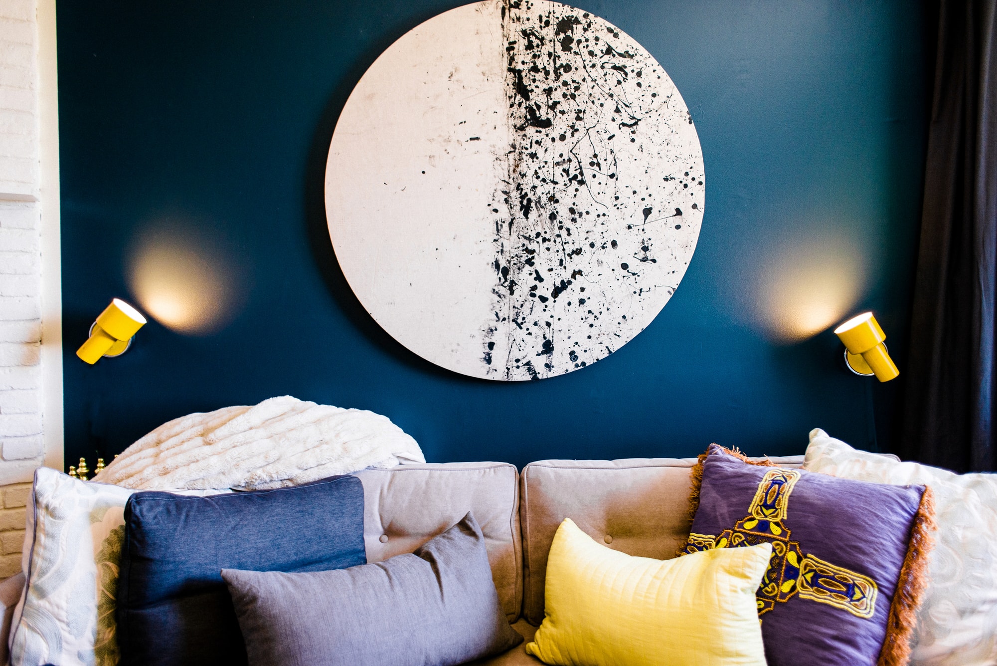 Sofa with round abstract art hanging above