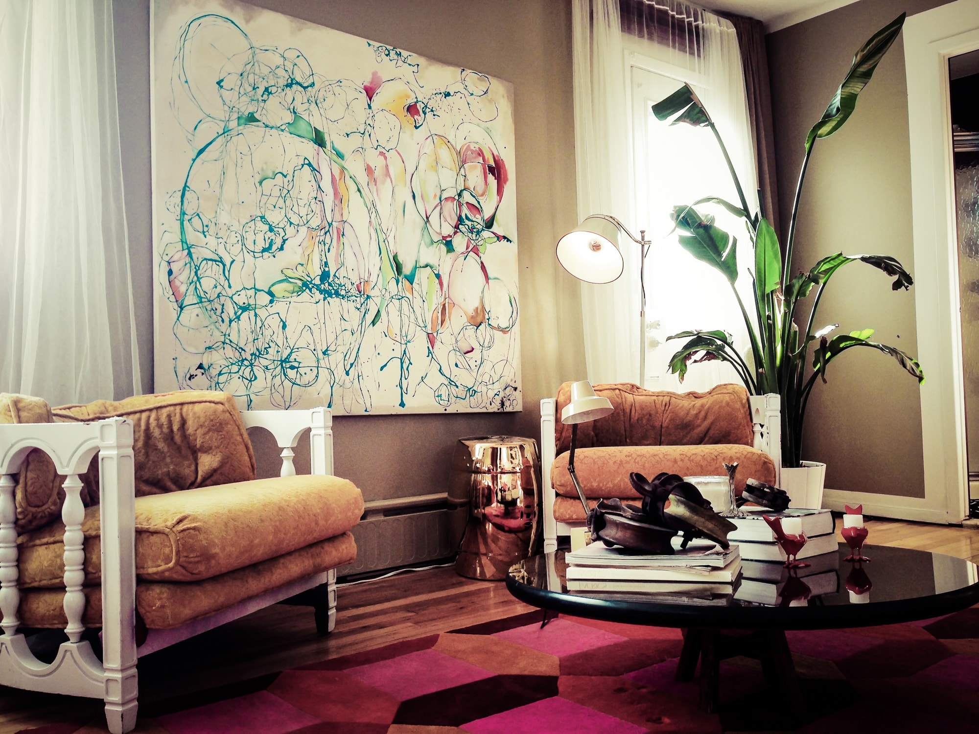 Sitting room area with abstract art hanging on wall
