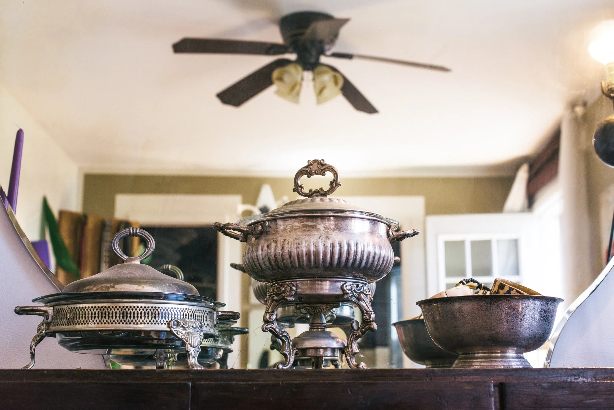 Wooden console with antique metal covered dishes