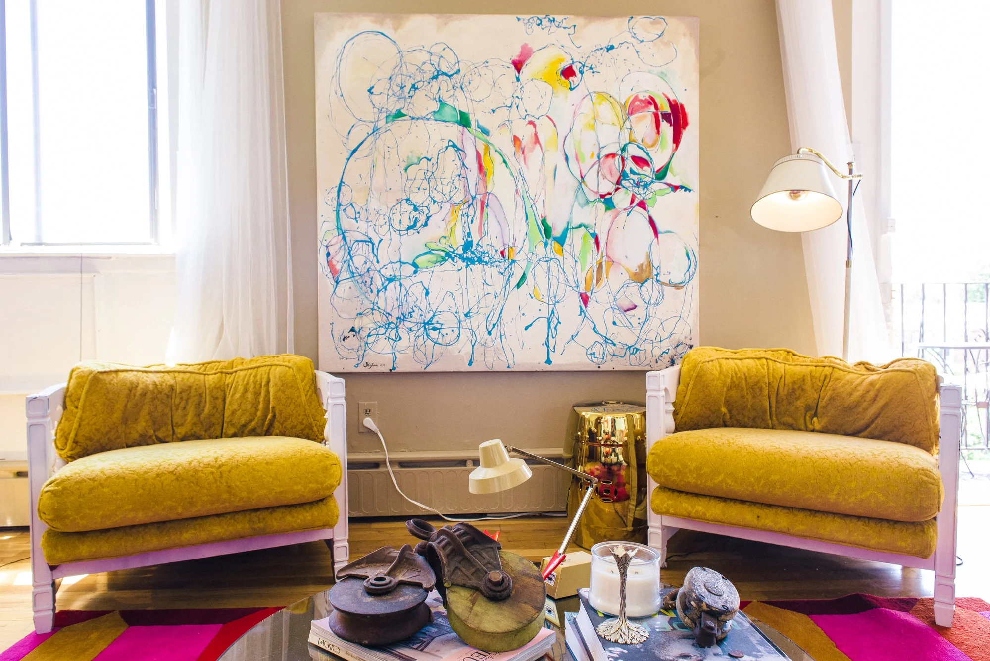 Sitting room area with abstract art on wall