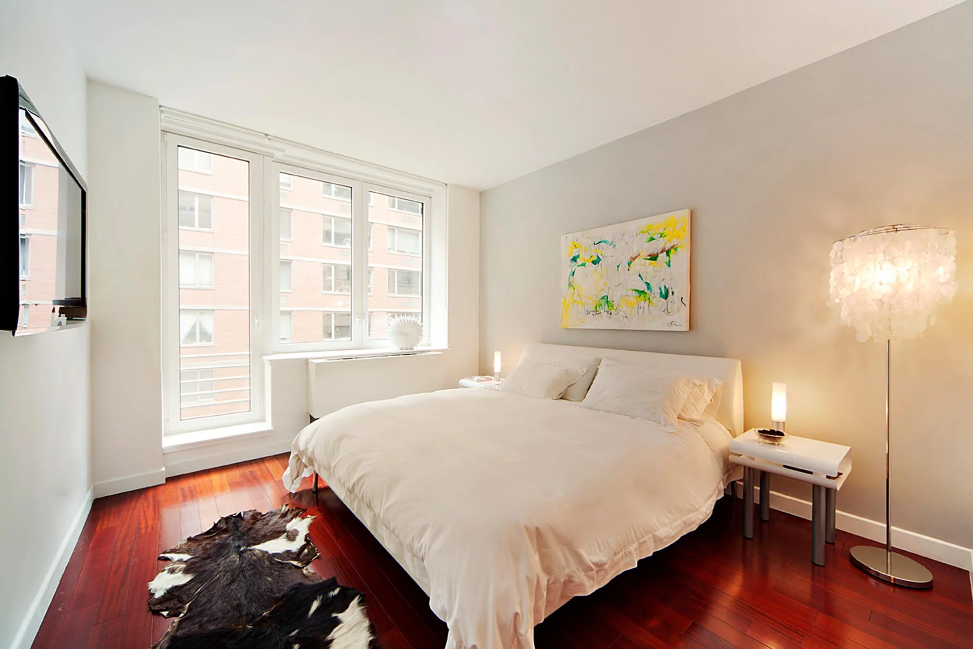 Bright bedroom with deep red wooden floors