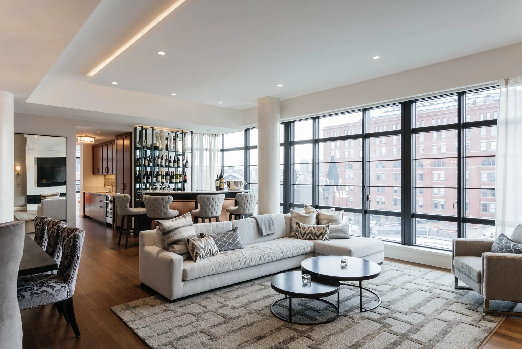 Open concept living room space with floor to ceiling steel frame windows