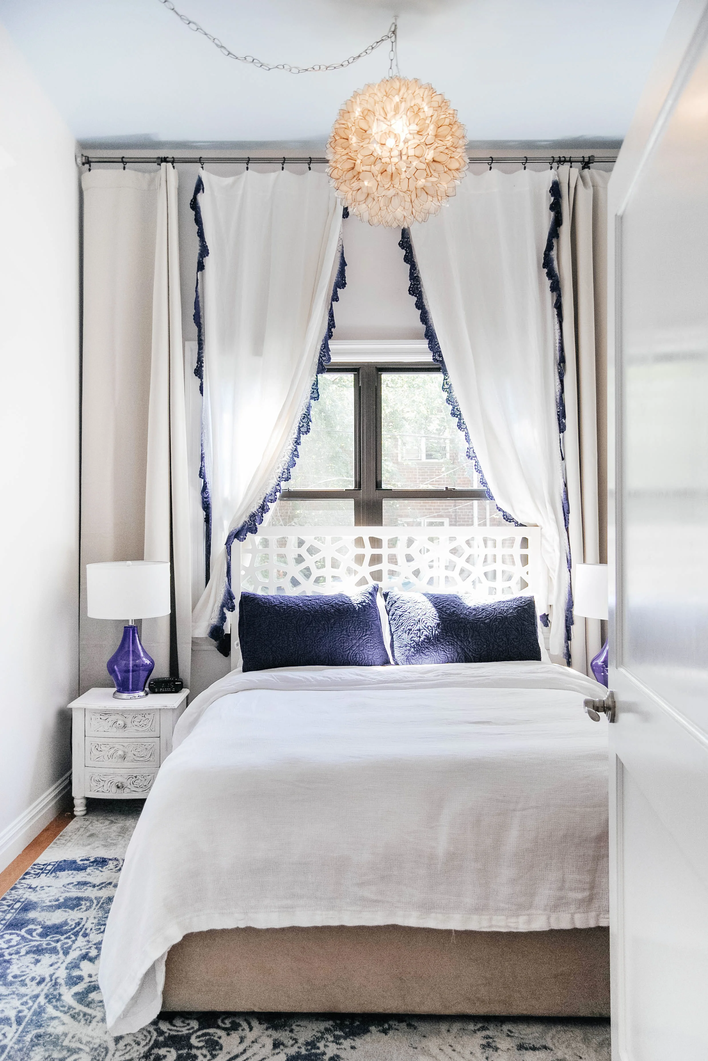 Bedroom with delicate window coverings