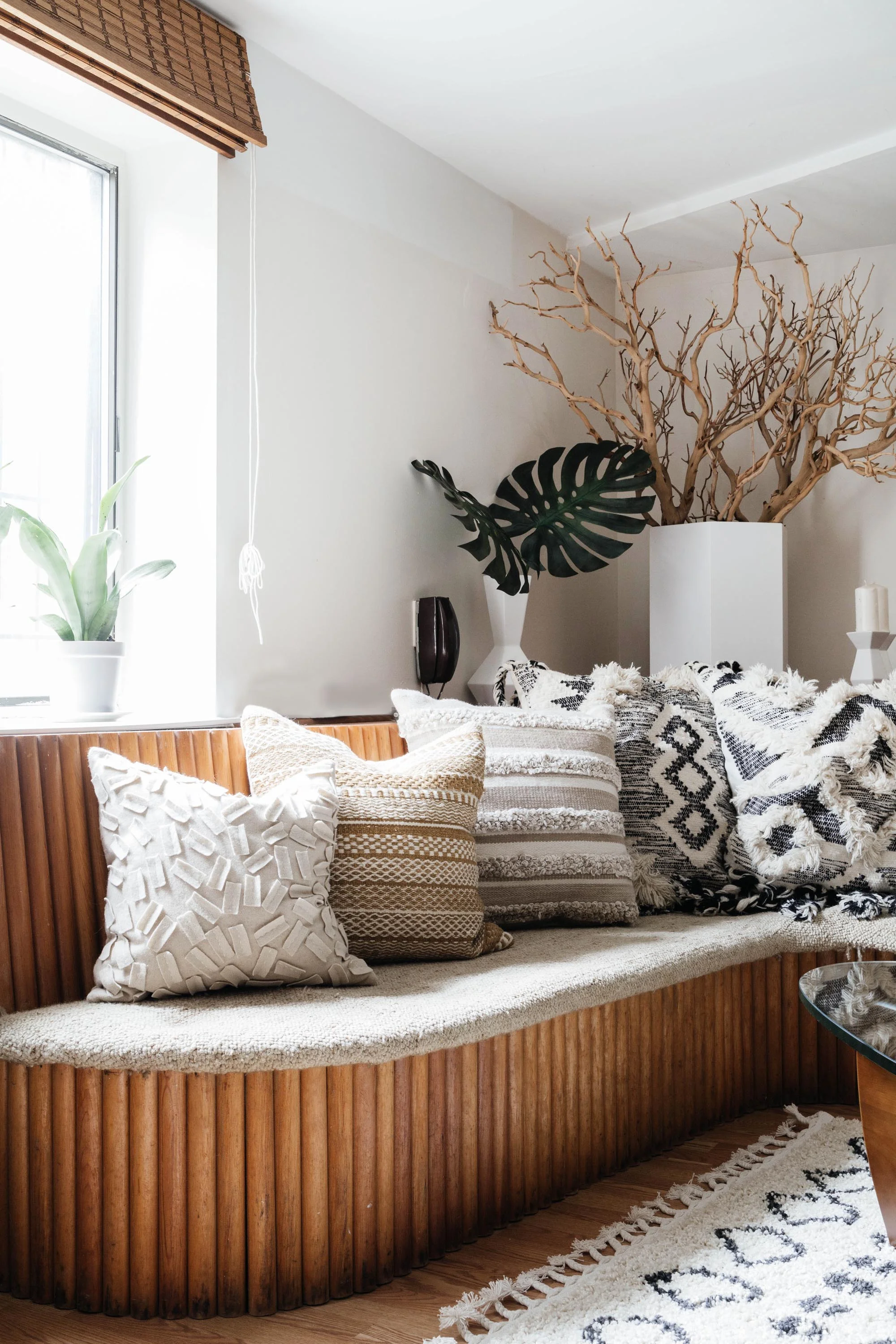 Custom built wooden sectional bench with throw pillows