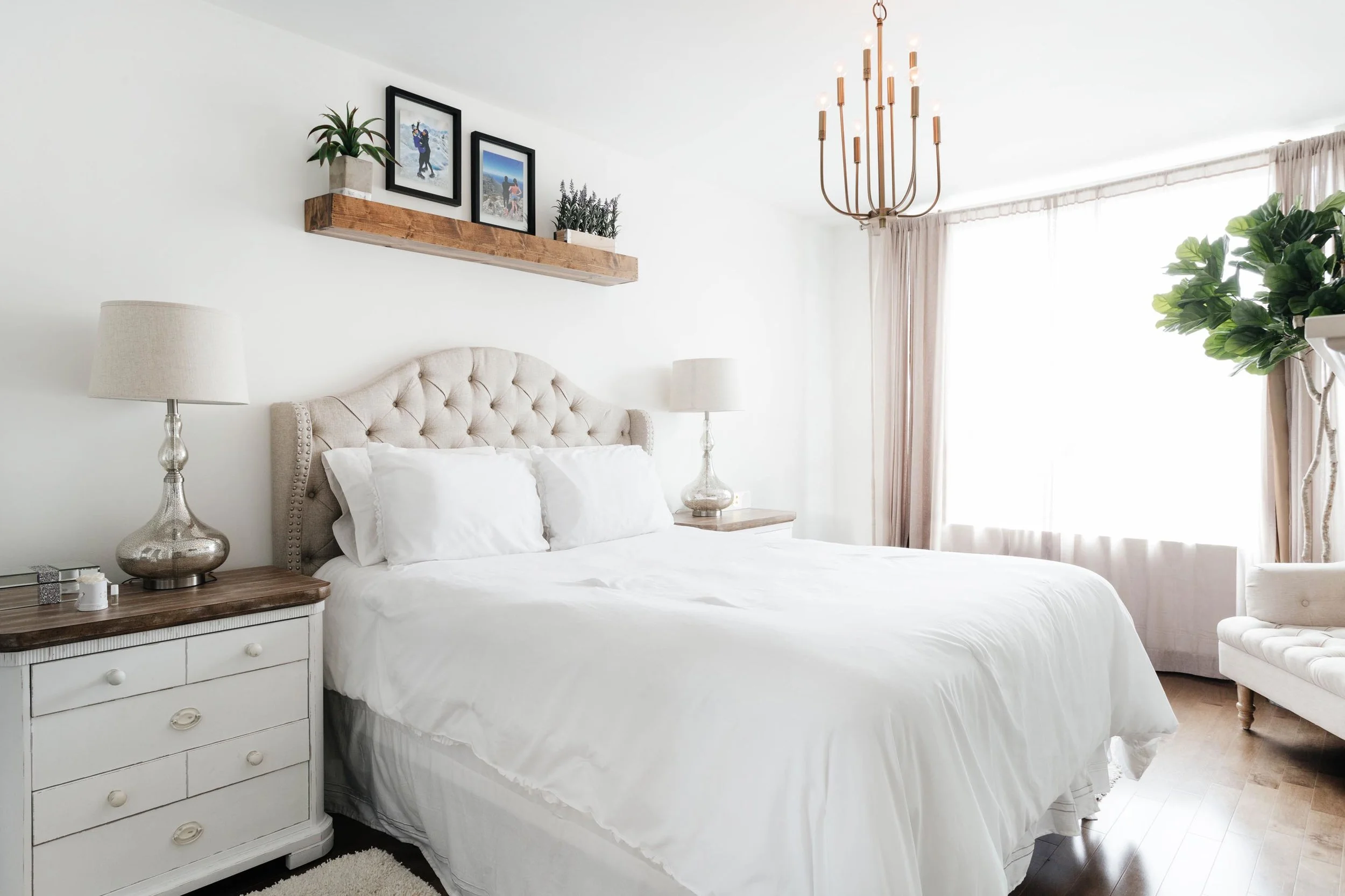 Bright bed room with wooden shelf hanging above bed