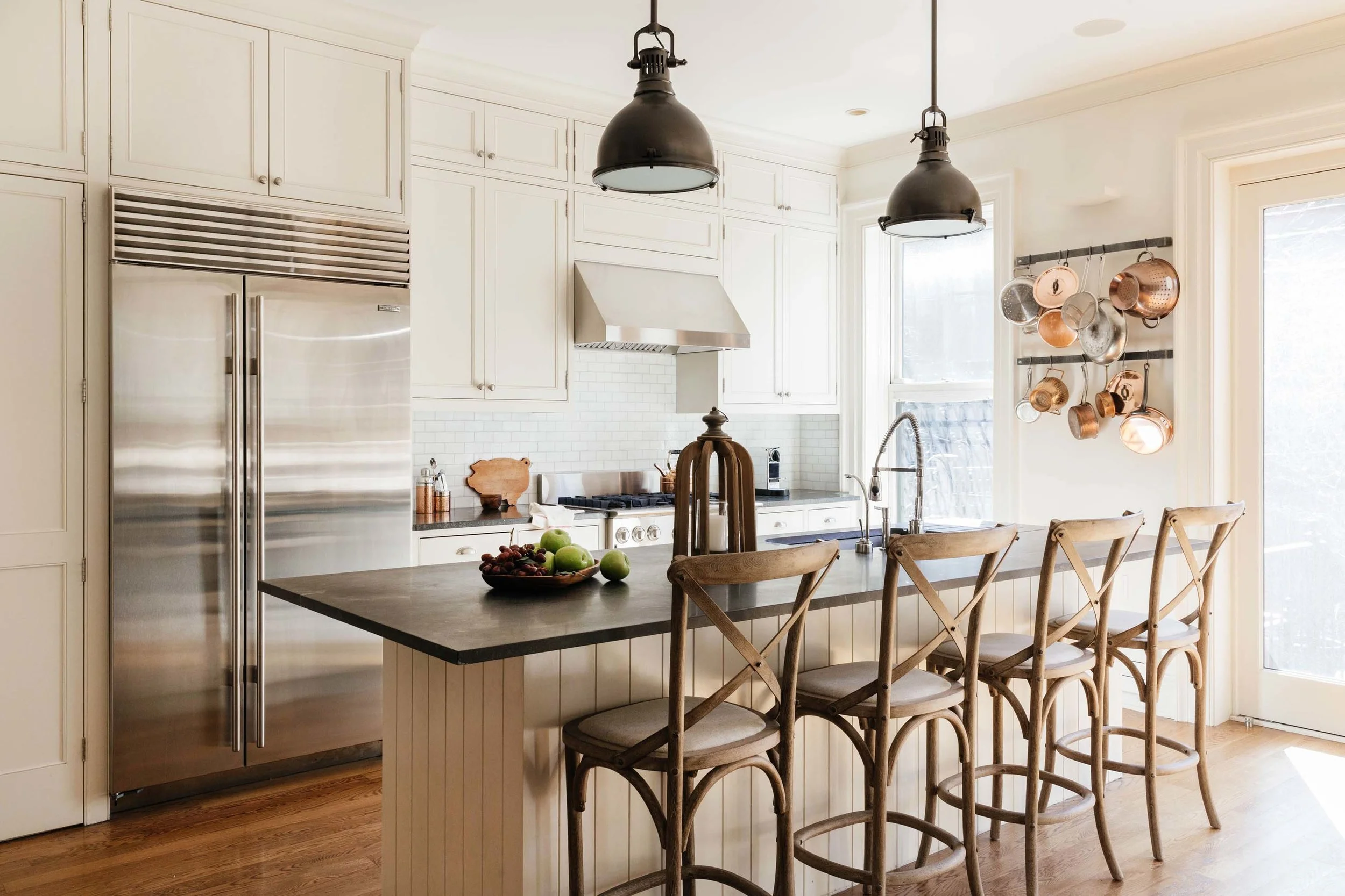 Rustic kitchen with chairs lining a central kitchen island
