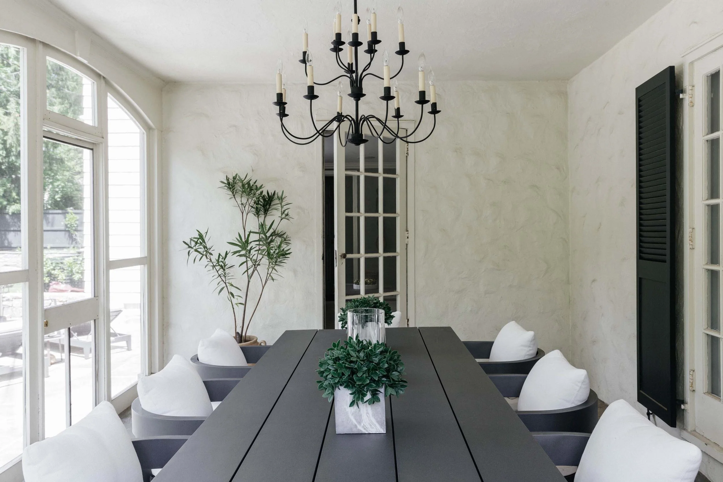Dining room with wooden table, chairs and chandelier