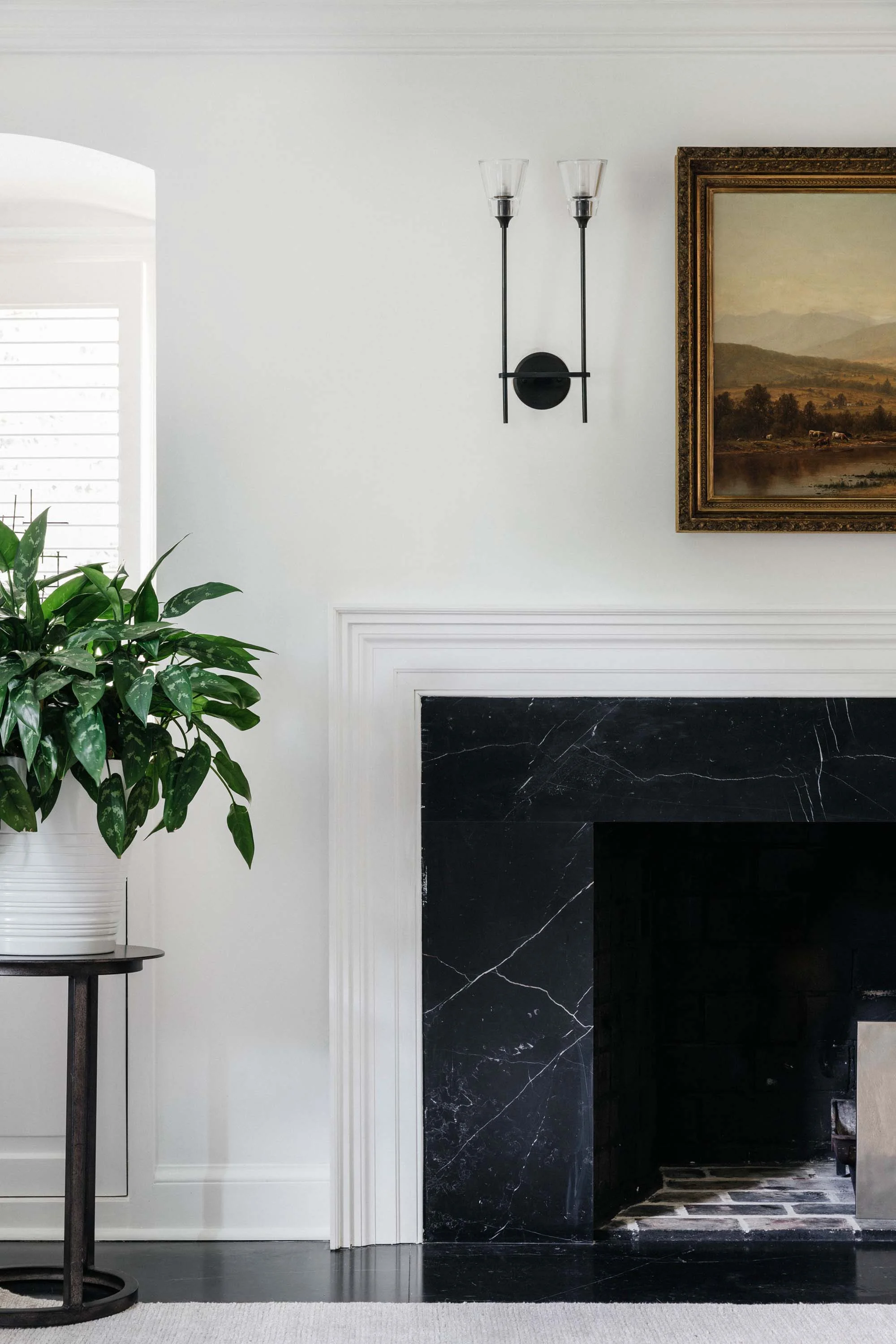 House interior with fireplace, frame on wall and indoor plant