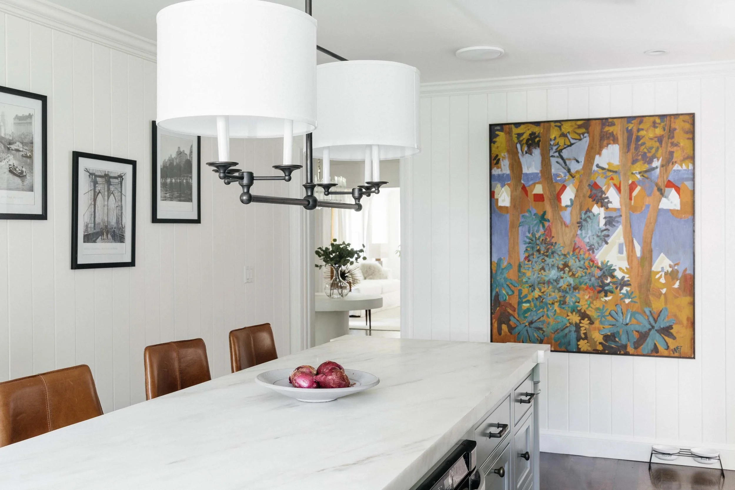 Kitchen with ceramic center island, frames and artwork on the wall