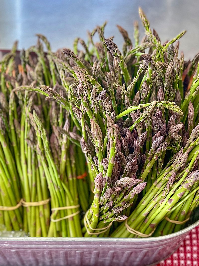 Bunches of fresh, organic asparagus from a local Northern Neck farm, displayed at the Old Farm Truck Market.