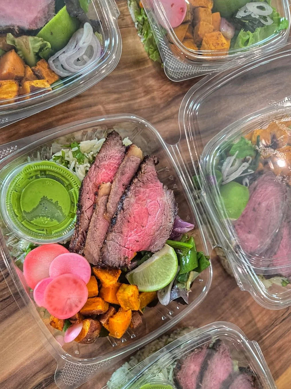 Freshly made carne asada bowl with local vegetables, orzo, parsley, and homemade sauce ready to take away or dine in at OFT To-Go.