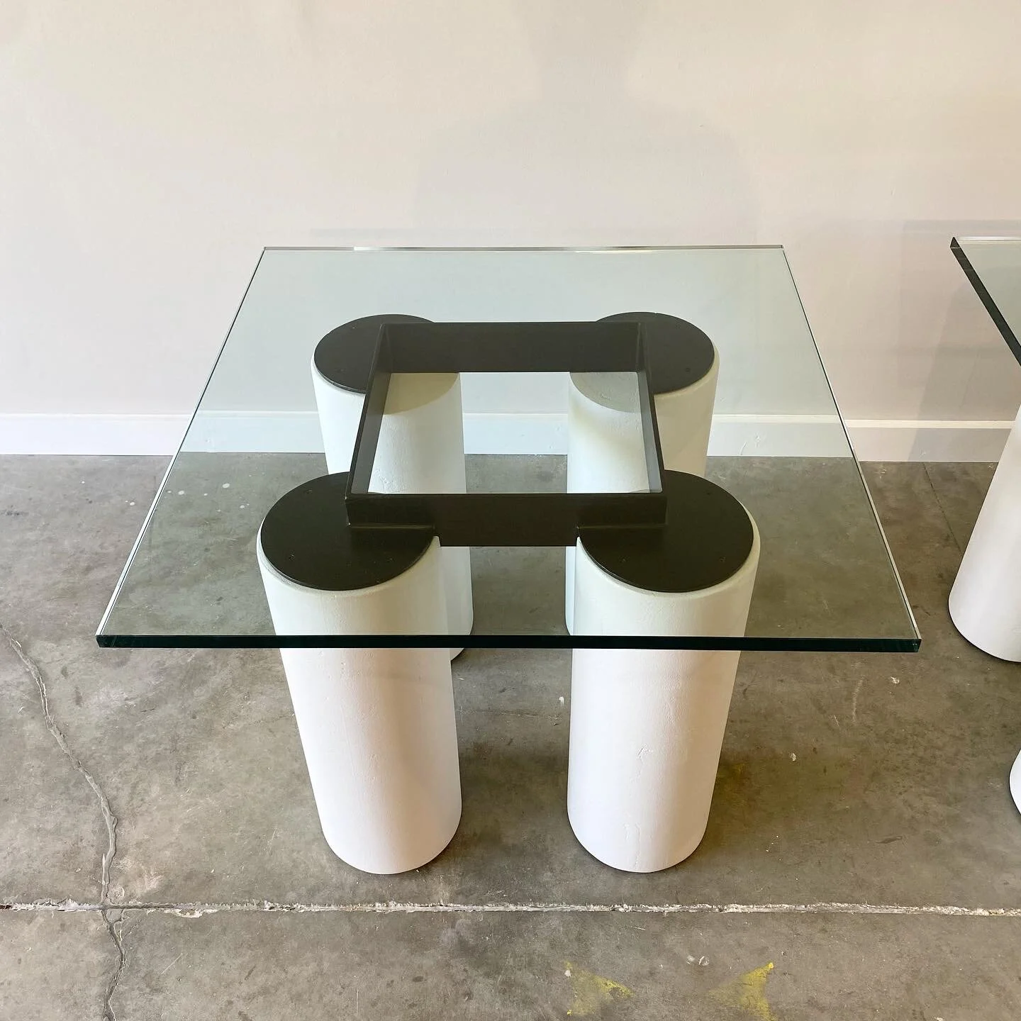 Post modern furniture in Raleigh. Exaggerated plaster columns with contrasting steel grid frame.