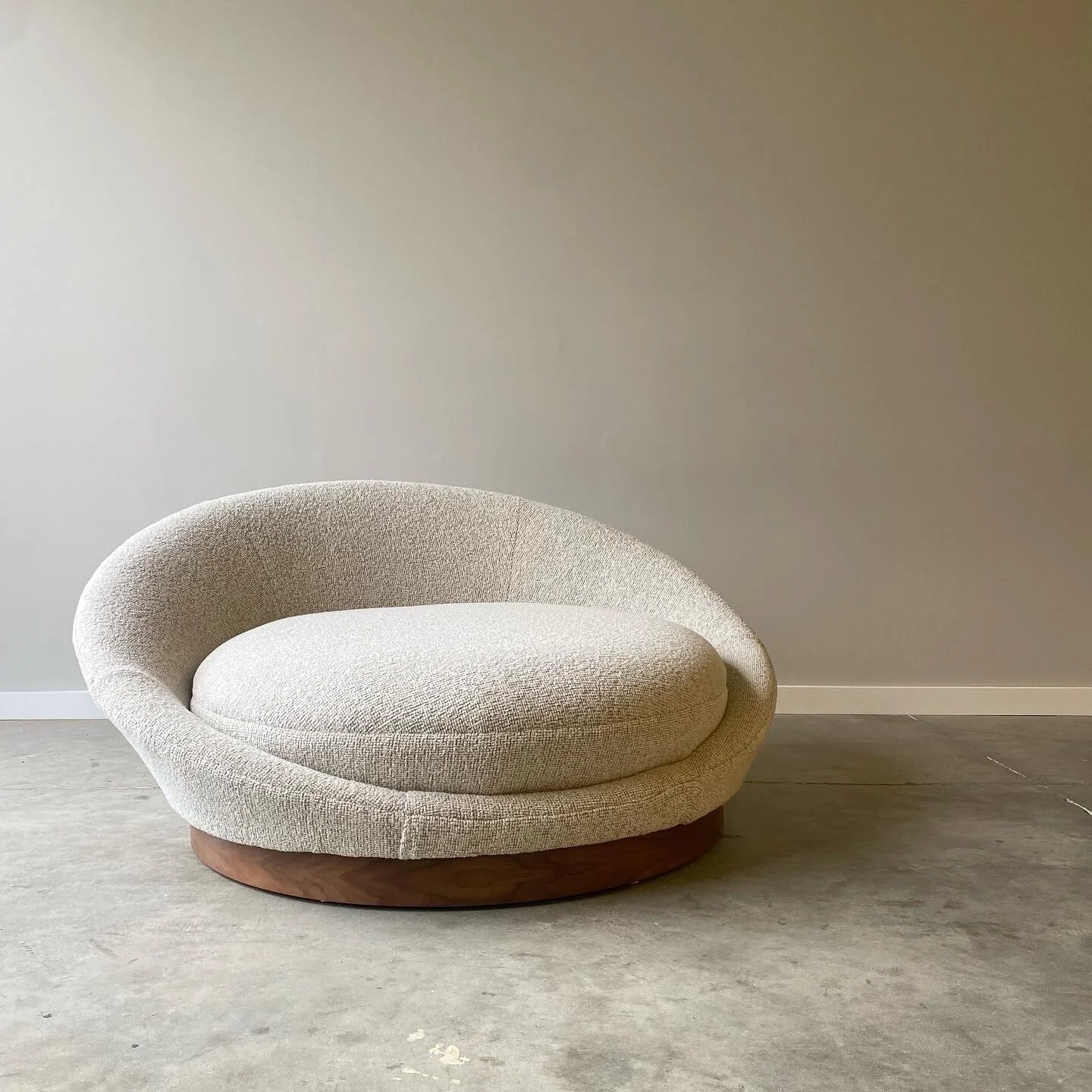 An incredibly comfortable statement piece from Milo Baughman.  Newly upholstered with restored walnut base.  