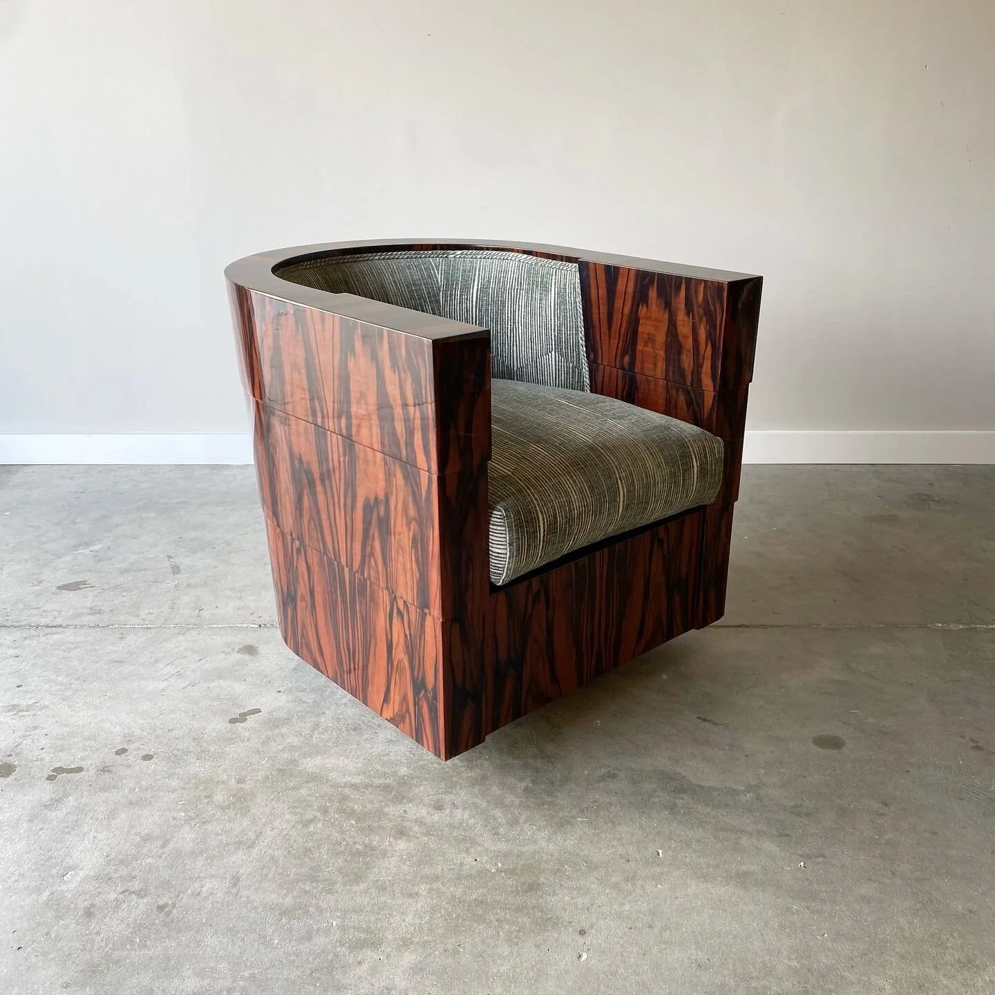 A stunning vintage example newly upholstered. Striking Macassar ebony case with gloss lacquer finish. 1970s swivel chair from Pace Furniture.   Minor imperfections to the case.