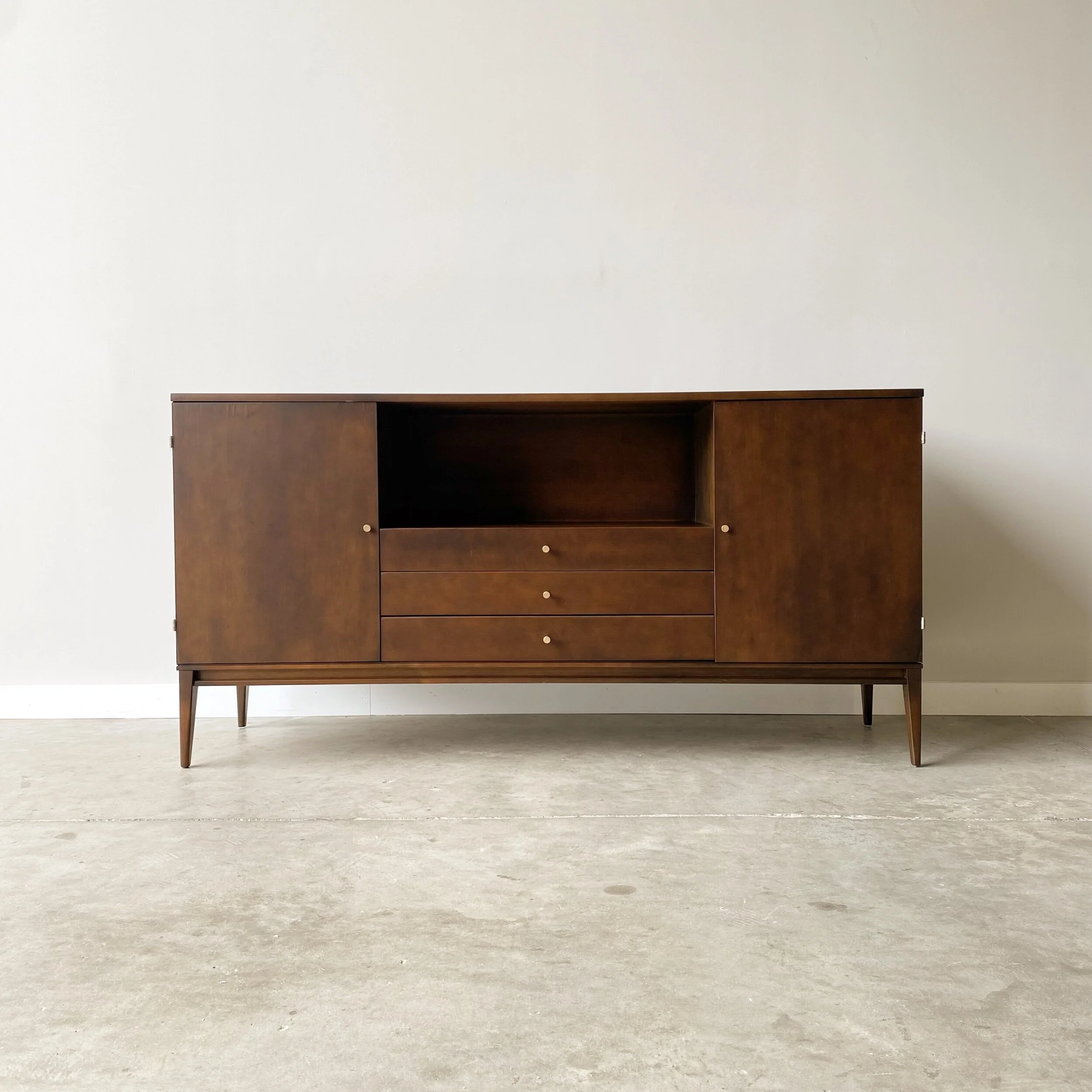 Paul McCobb Credenza $2,195.00 1950s media cabinet from the Paul McCobb Planner Group, Winchendon.   A classic mid century modern form maybe of solid mable with walnut finish.