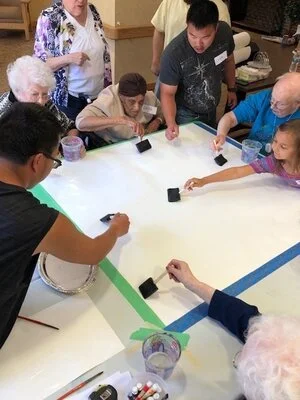 Aric and Sean Turrell demonstrate painting techniques