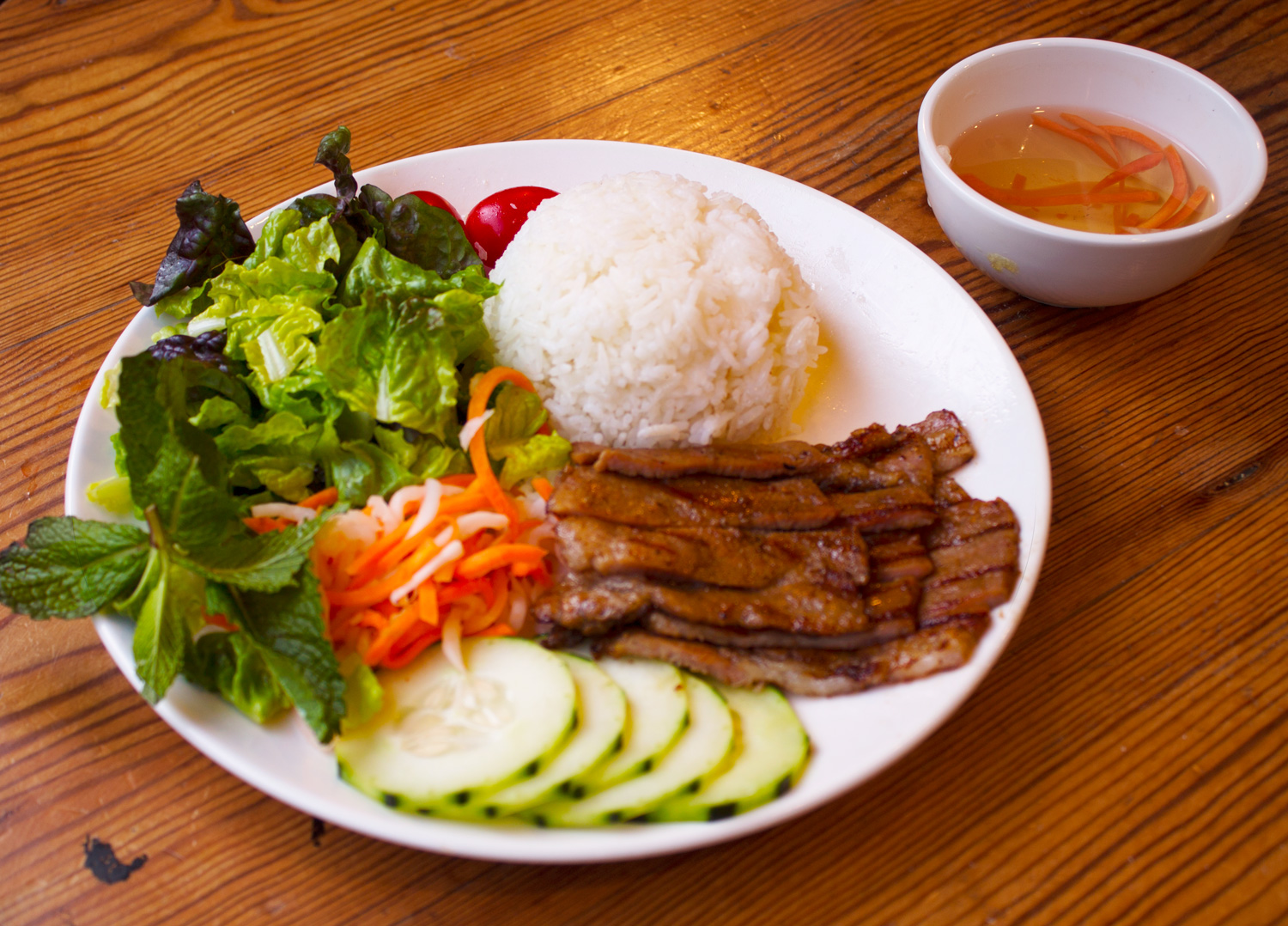 Grilled pork rice entree served with Vietnamese Vinaigrette dressing