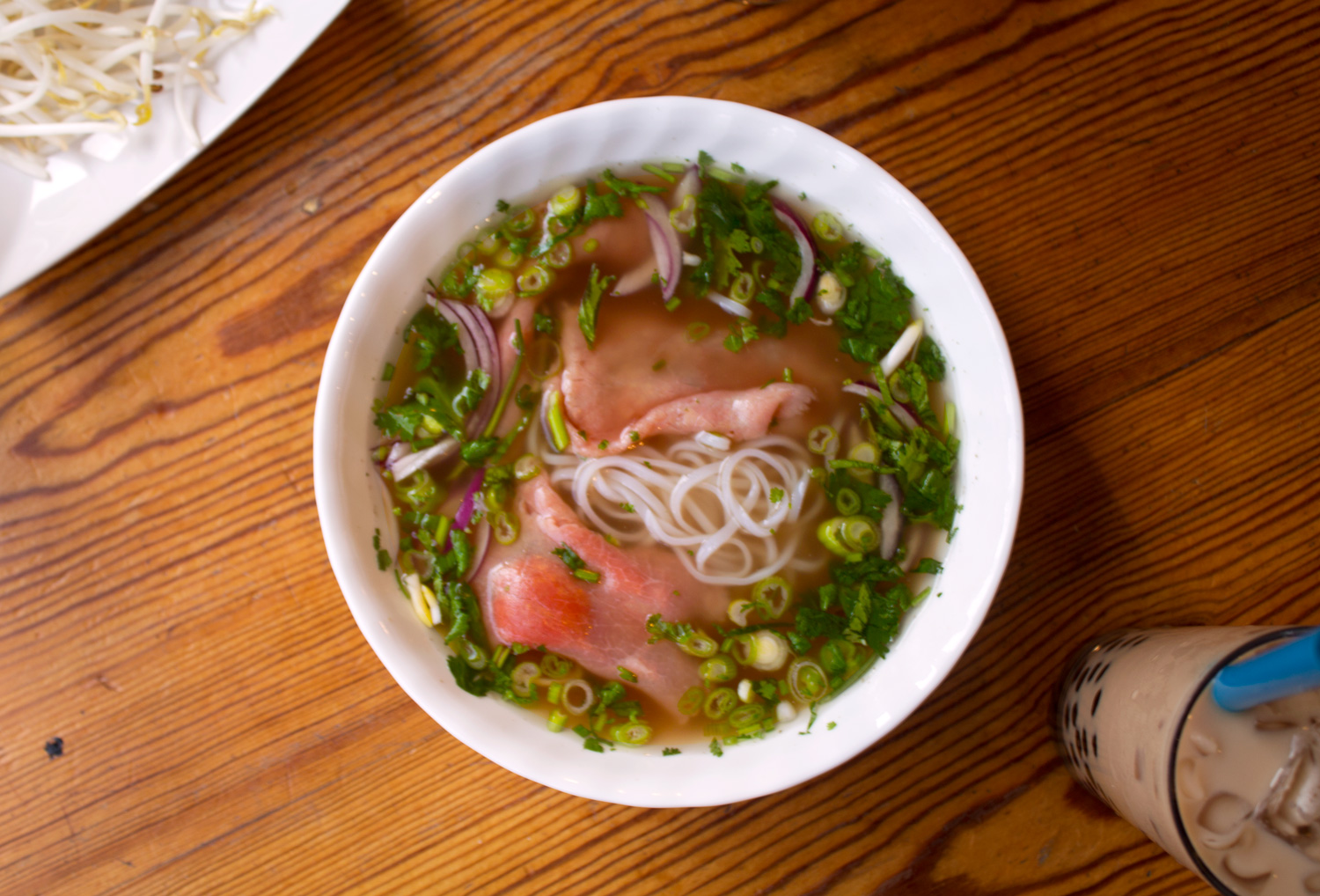 Beef pho vietnamese noodle soup served with bubble tea