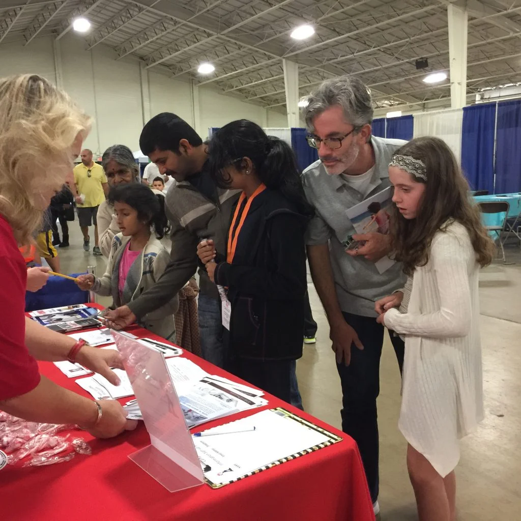 (Left, Myrna L. Smith): Visitors enjoy the Future Construction Leaders Foundation display at the 2016 STEAM Maker Festival.