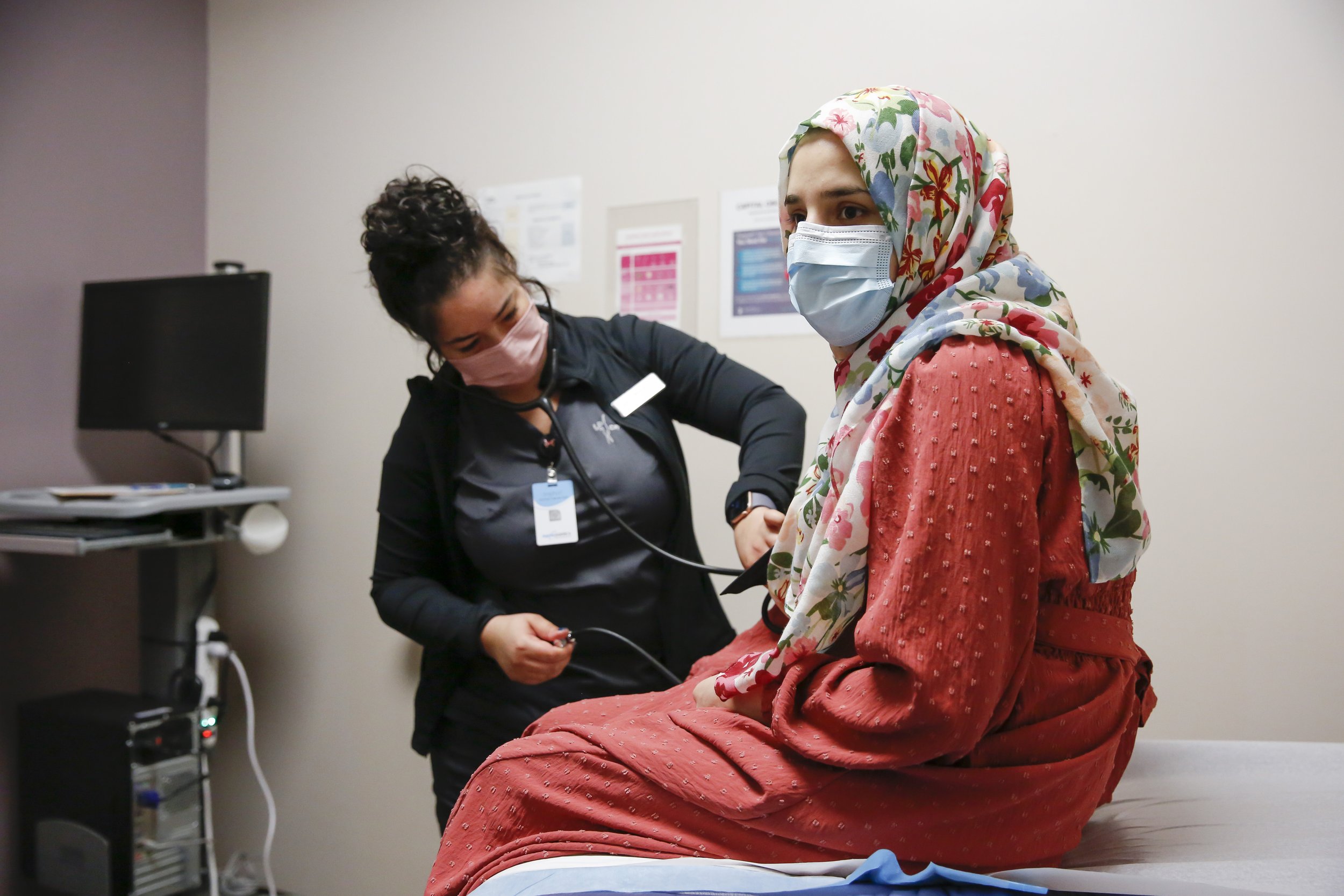  Susan Mohammadi has her blood pressure taken during an OBGYN appointment in Sacramento, Calif. on Tuesday, December 28, 2021. Najibullah Mohammadi, his wife Susan, their two young children Zahra and Yasar, and their soon-to-be born third child Yusuf