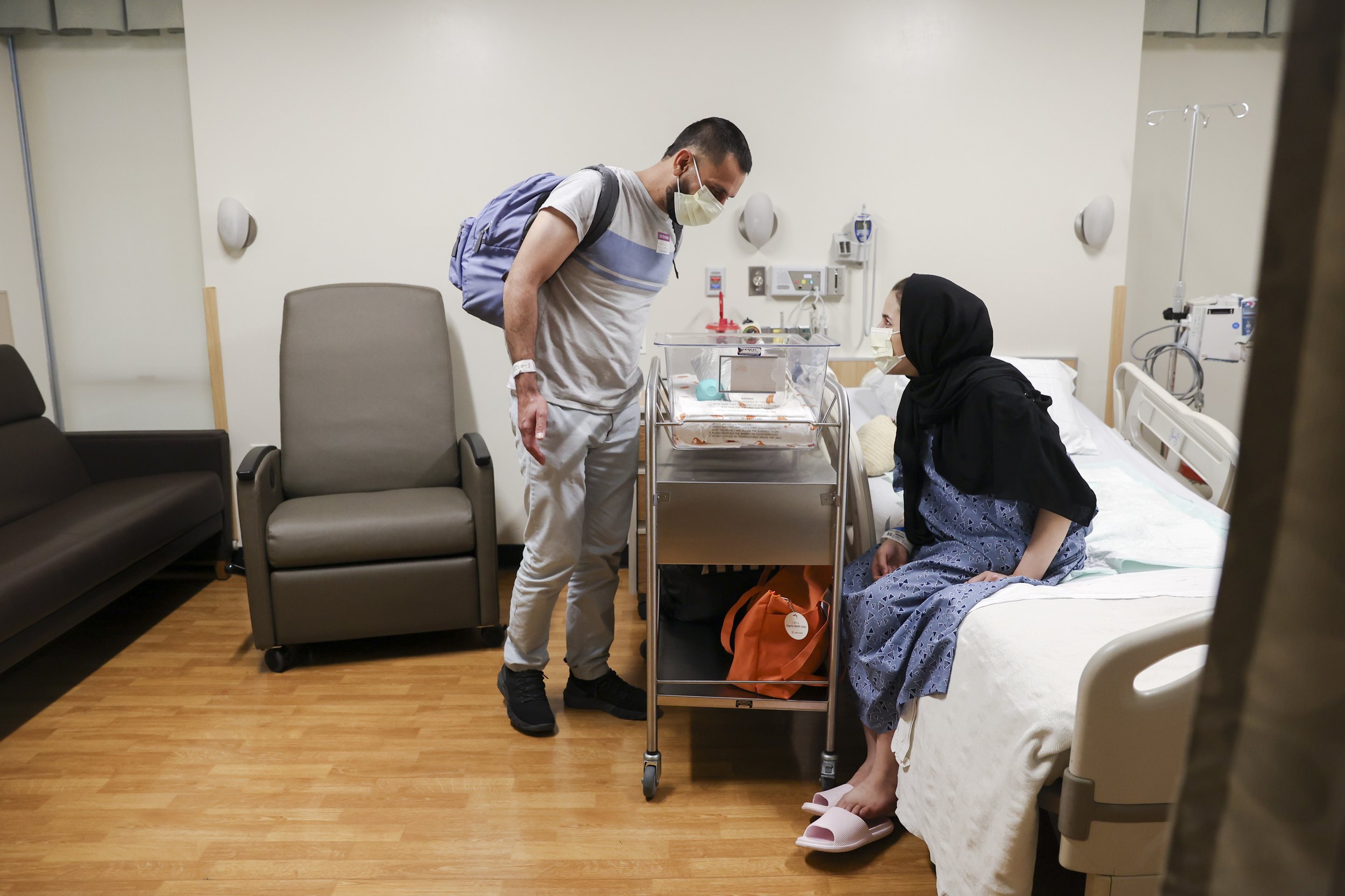  Najibullah Mohammadi and his wife Susan look at their newborn son, Yusuf Mohammadi, as he lays in his crib at Mercy San Juan Hospital on Thursday, May 12, 2022. After spending over an hour at the Sutter Hospital, the Mohammadi family was informed th
