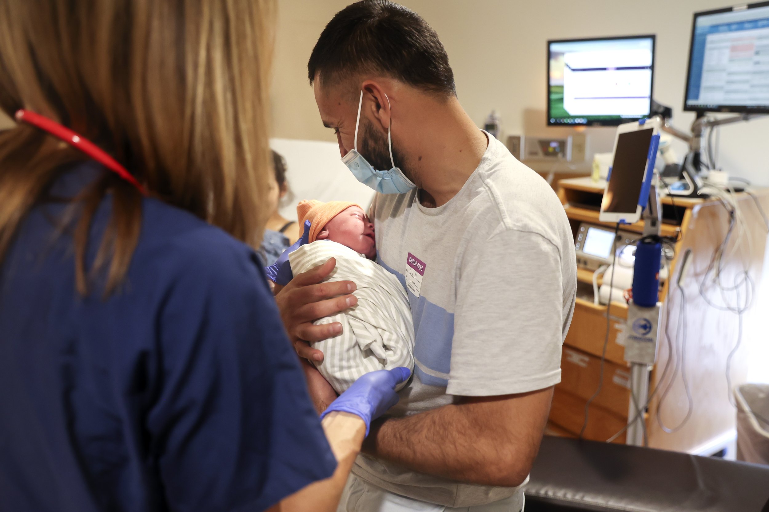  Najibullah Mohammadi holds his newborn son, Yusuf Mohammadi, for the first time at Mercy San Juan Hospital on Thursday, May 12, 2022.After spending over an hour at the Sutter Hospital, the Mohammadi family was informed that there were no female doct