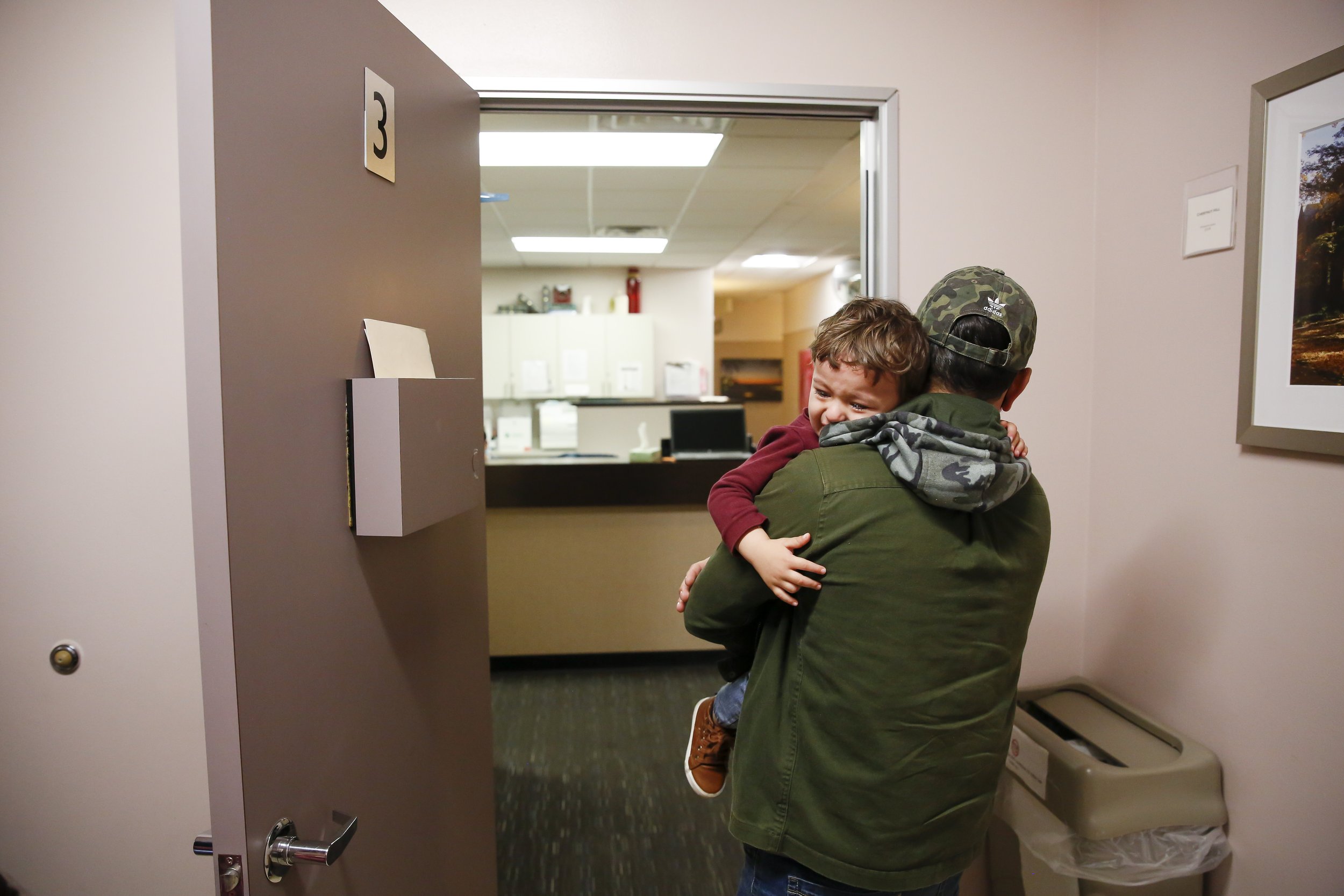  Najibullah Mohammadi carries his crying son Yasar (2) out of the patient room at the doctor’s office during Susan’s OBGYN appointment in Sacramento, Calif. on Thursday, April 21, 2022. Najibullah Mohammadi, his wife Susan, their two young children Z