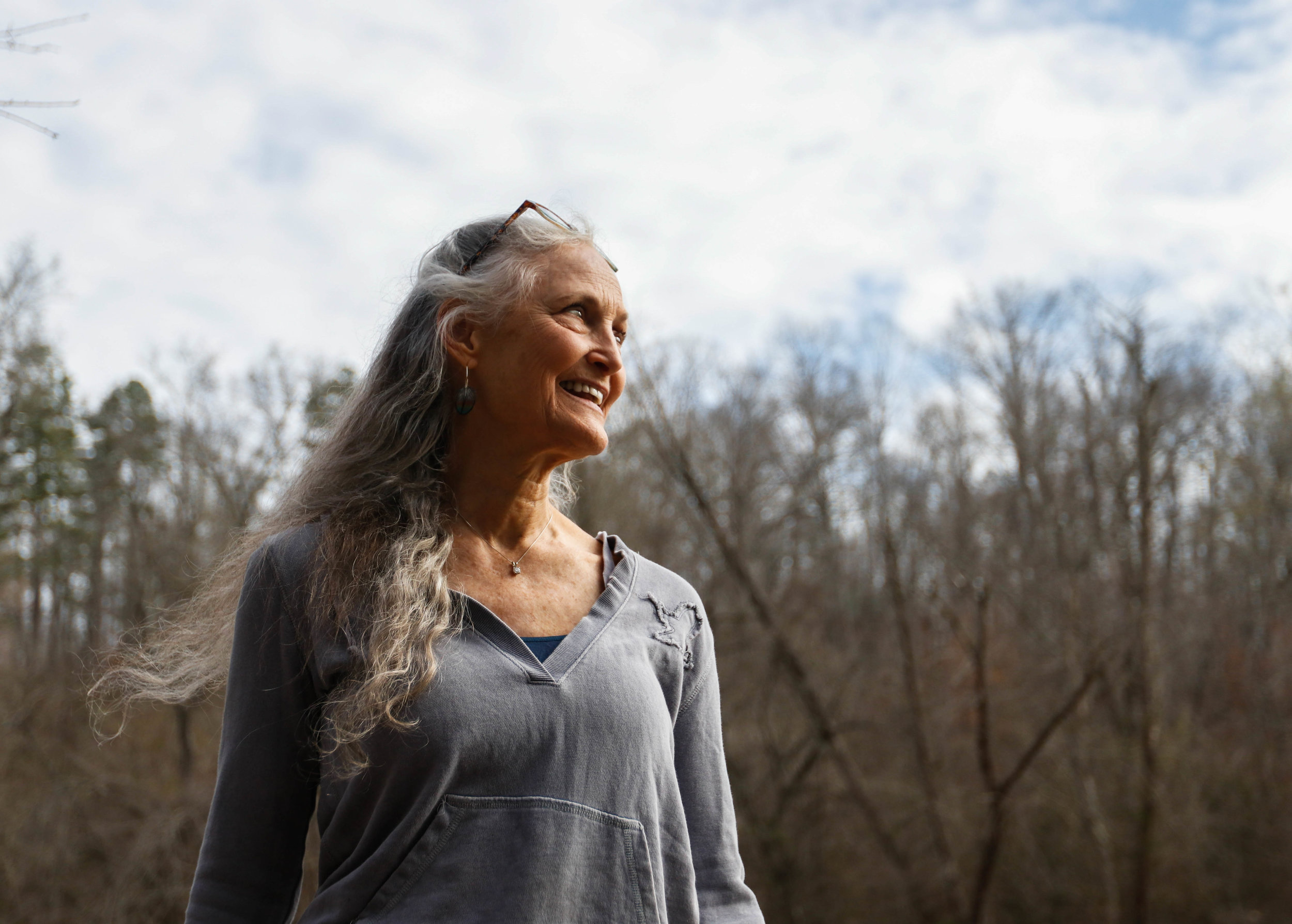  Tinsley breathes in the fresh air by the Middle Oconee River, in Bogart, Georgia on Saturday, Feb. 24, 2018. A portion of Earthsong’s electricity is powered by the river's flow, but more important to Tinsley is the sense of healing she feels wheneve