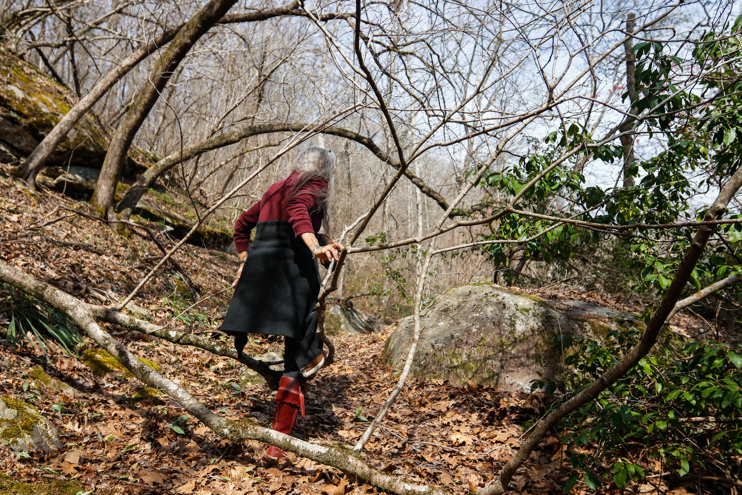  Tinsley takes a walk through the forest at Earthsong on Friday, March 16, 2018. "I like walking through the forest, the dark and deep woods," Tinsley said. From sleeping under the stars by the river to picking wildflowers to make tea, she spends muc