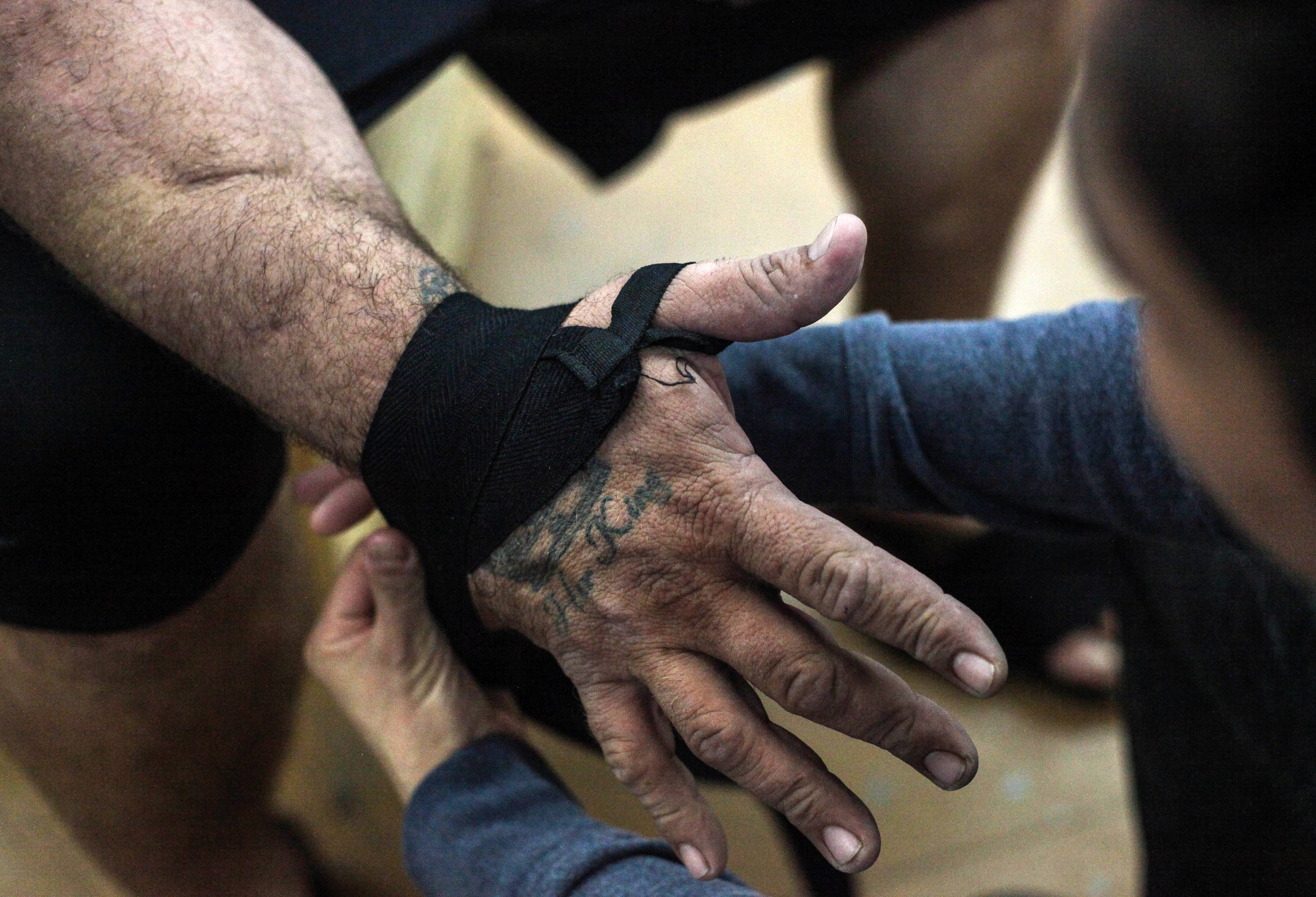  Stacy Aguilar wraps her husband Johnny's hands at Victoria Brazilian Jiu-Jitsu in Victoria, Texas on Wednesday, Sept. 26, 2018. He proposed to her during one of her first mixed martial arts fights and the rest is history, Aguilar says. 