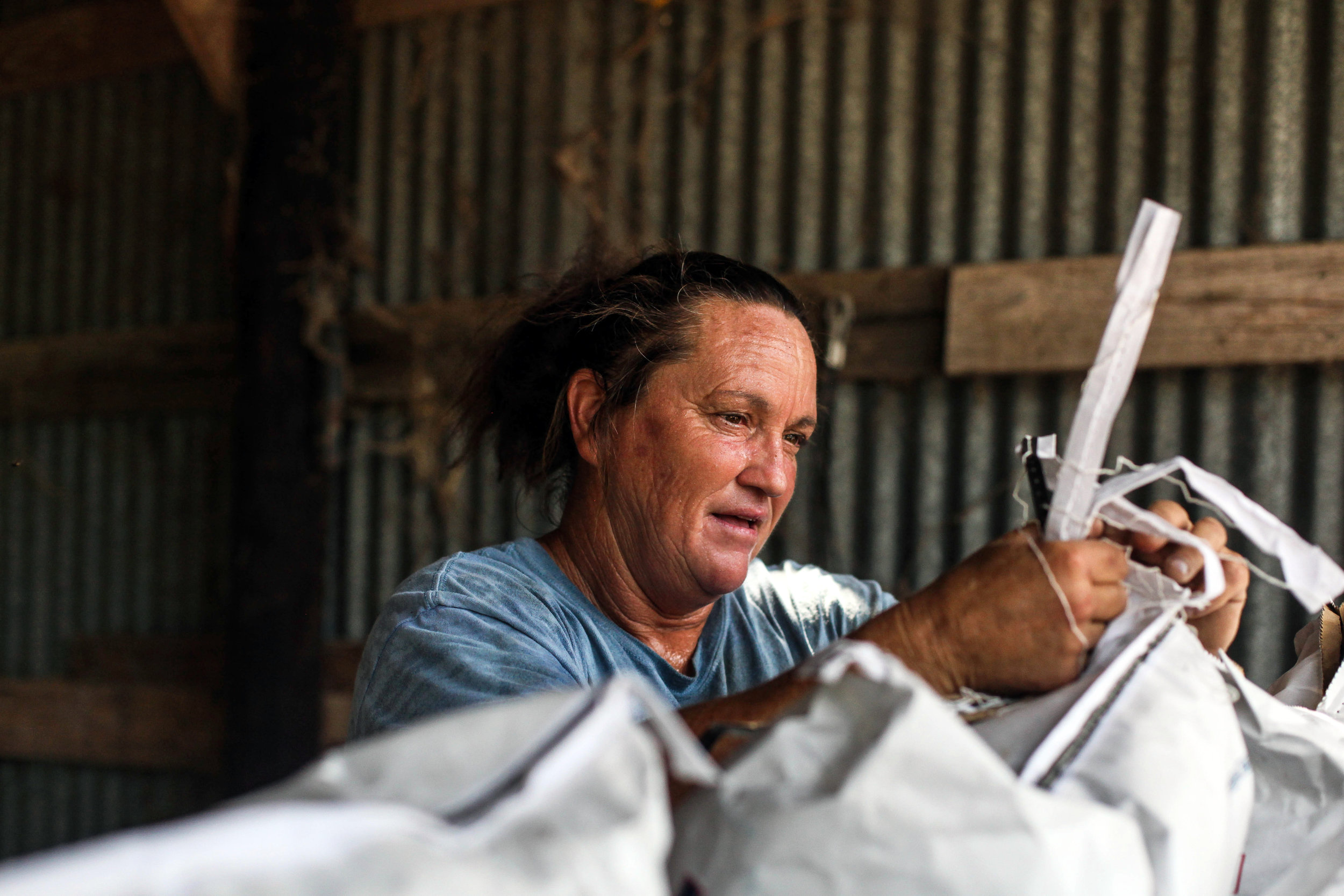  Darla Cherry, 54, opens bags of feed at Meadow Haven Horse Rescue on Tuesday, Sept. 25, 2018. 