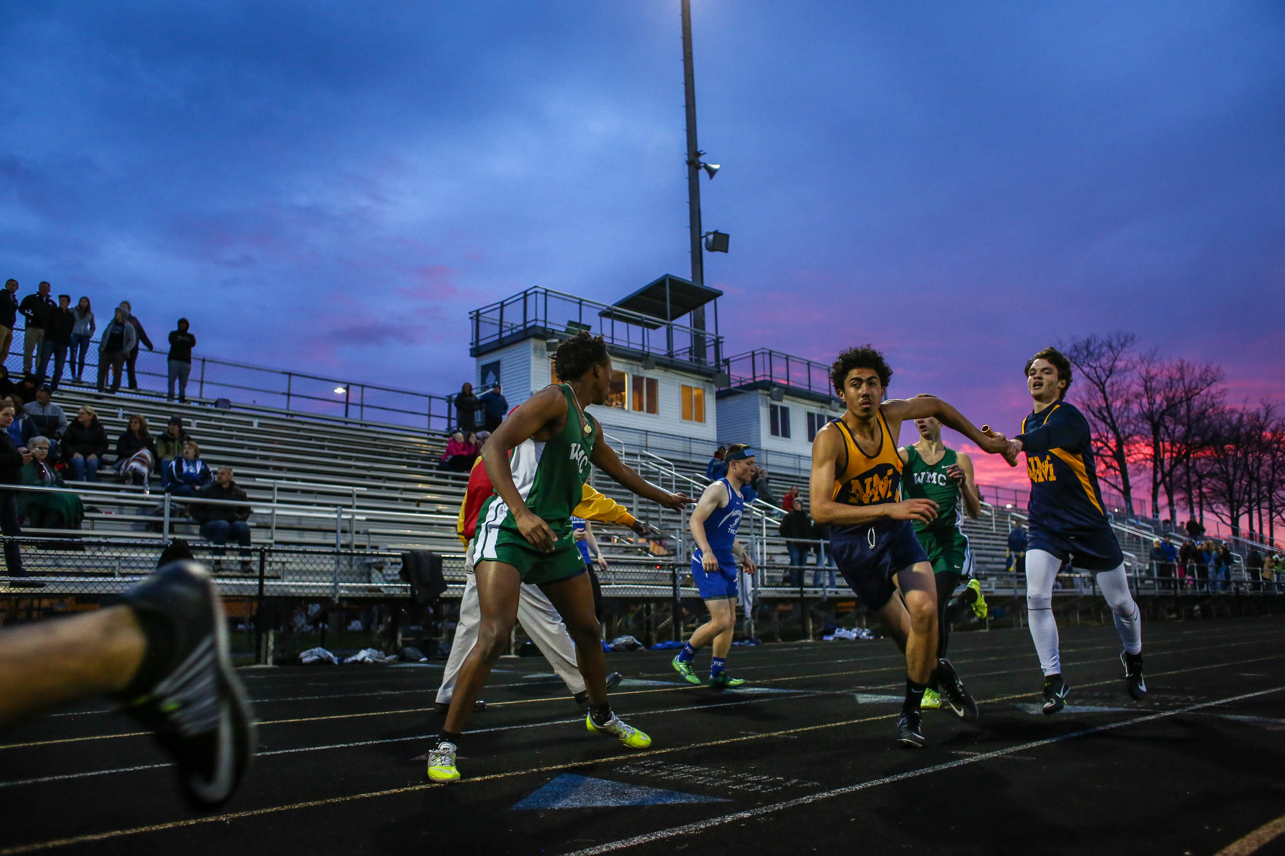  Runners make baton exchanges in the varsity boys 4x400-meter relay race during Friday's GMAA track and field meet at Fruitport High School in Fruitport, Michigan on May 3, 2019. 