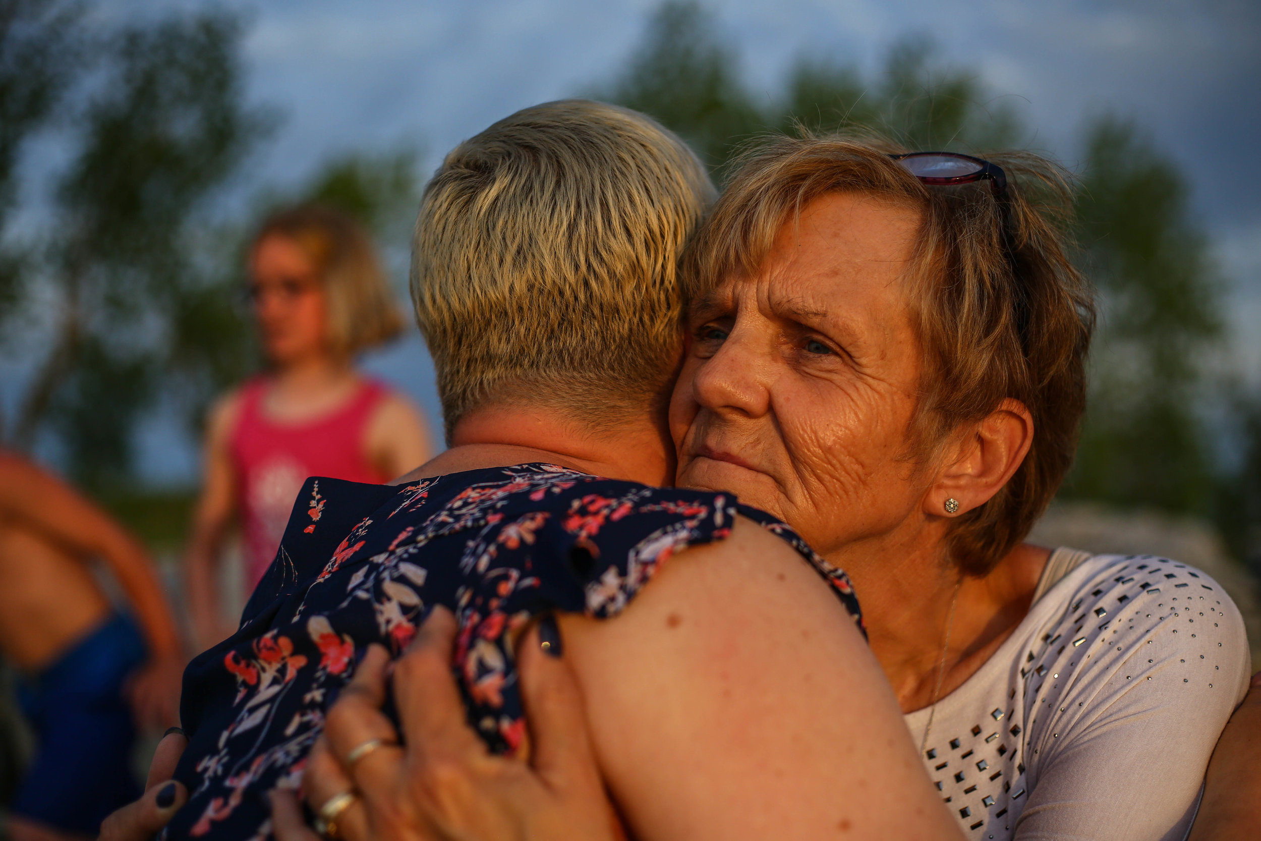  Amanda's mother Janet gives her a hug while Kayla and Cameron play in the background at Muskegon State Park, in Muskegon, Michigan on Saturday, June 8, 2019. 