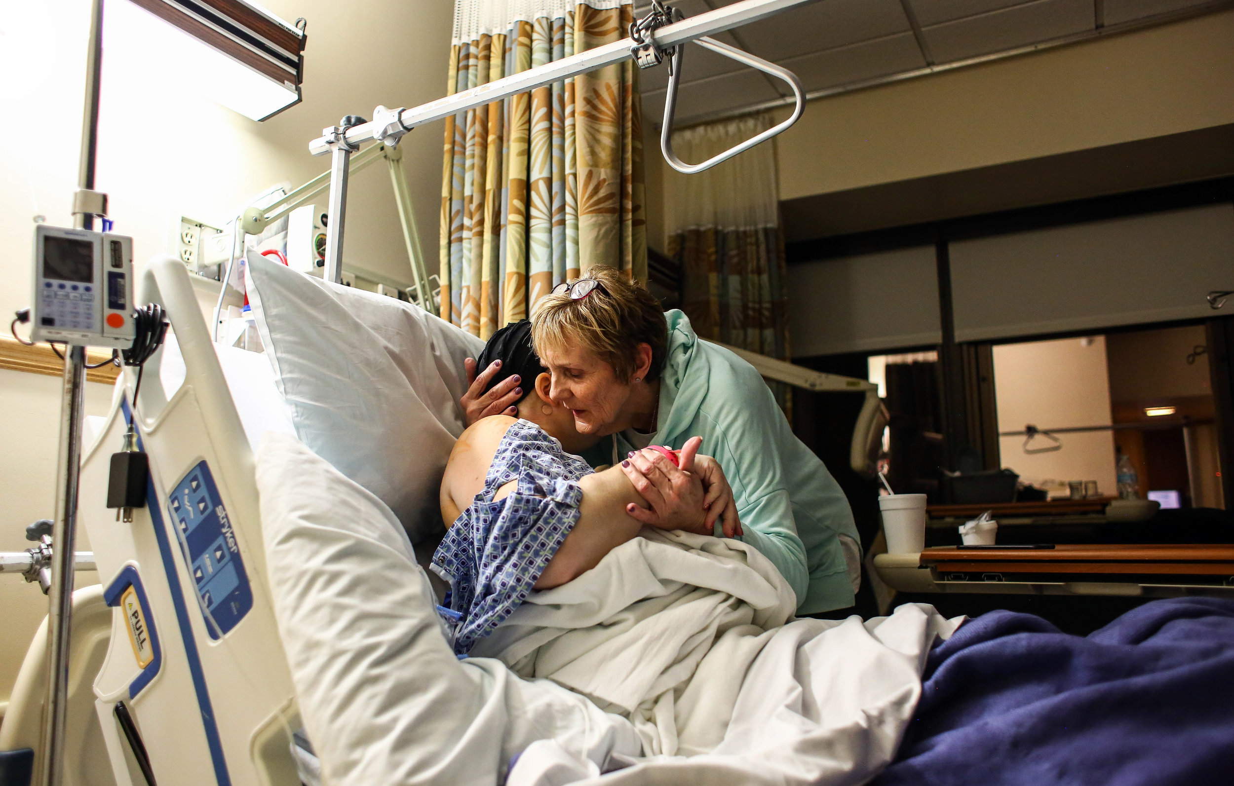  Janet Wegner hugs her daughter Amanda Cihak after her double mastectomy surgery at the Mercy Health Hackley Campus, in Muskegon, Michigan on Thursday, March 14, 2019. Wegner is a stage 3 breast cancer survivor; it pains her to see her daughter go th
